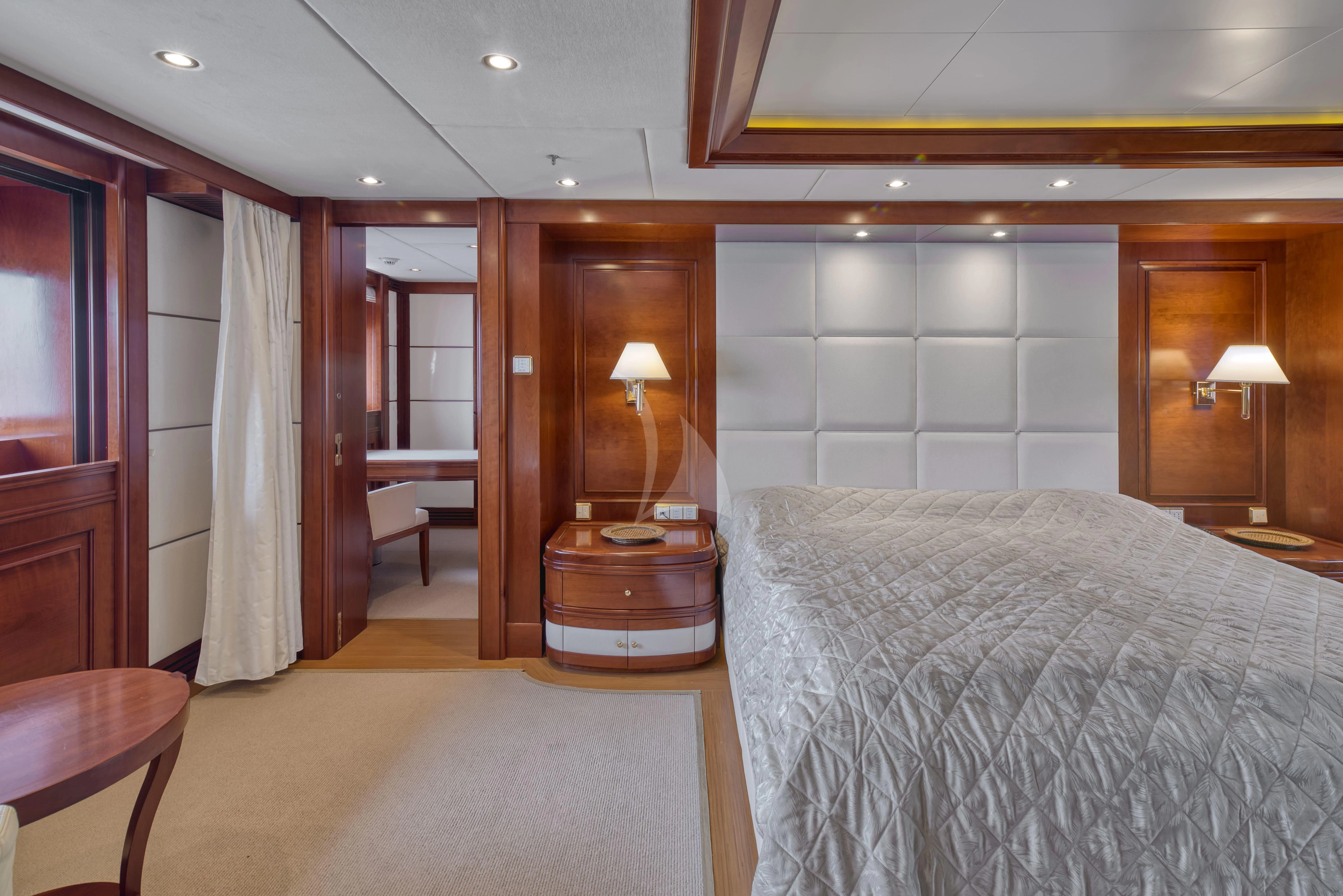 a hotel room with a bed and a table aboard TIREA Yacht for Sale