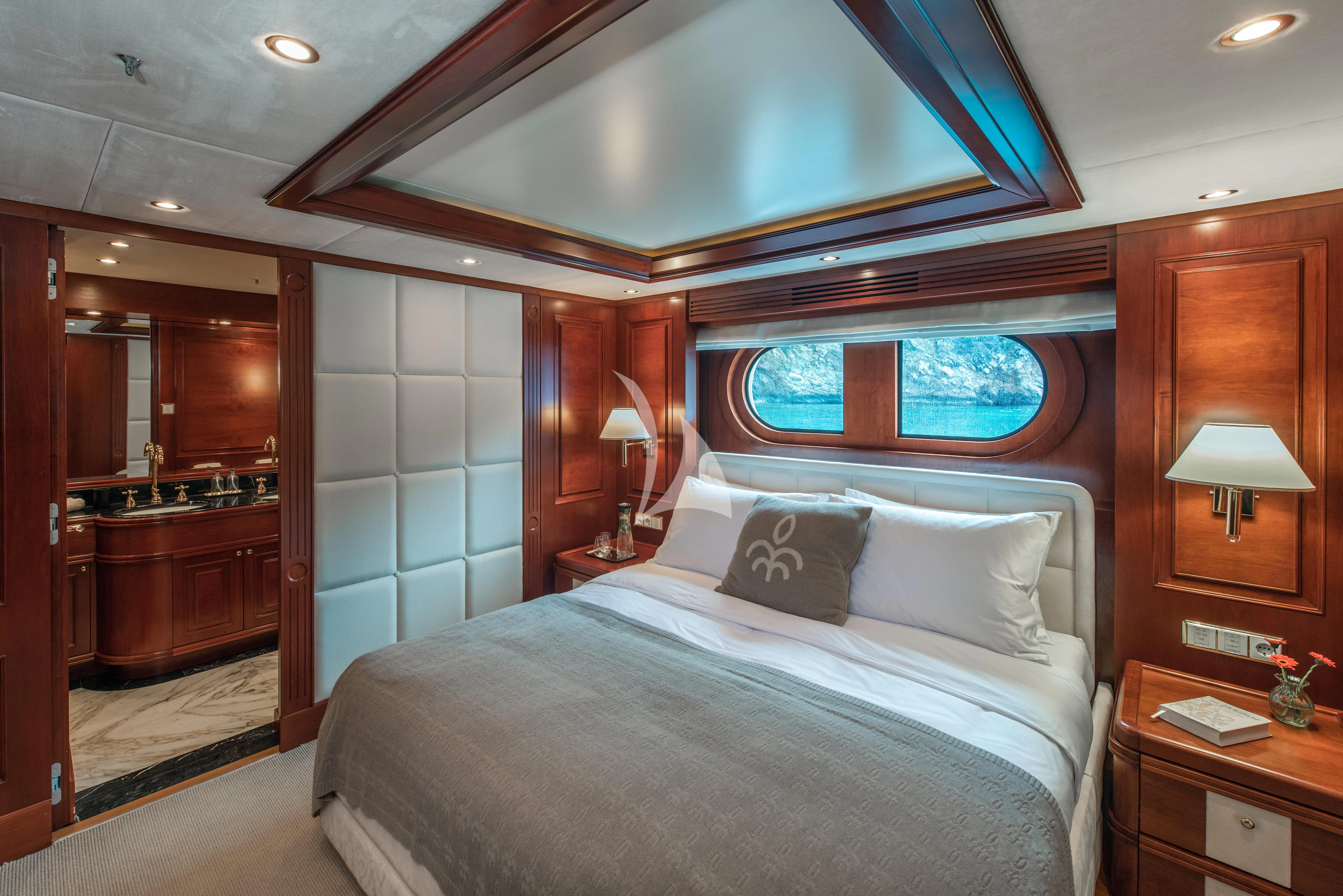 a bedroom with a large bed aboard TIREA Yacht for Sale