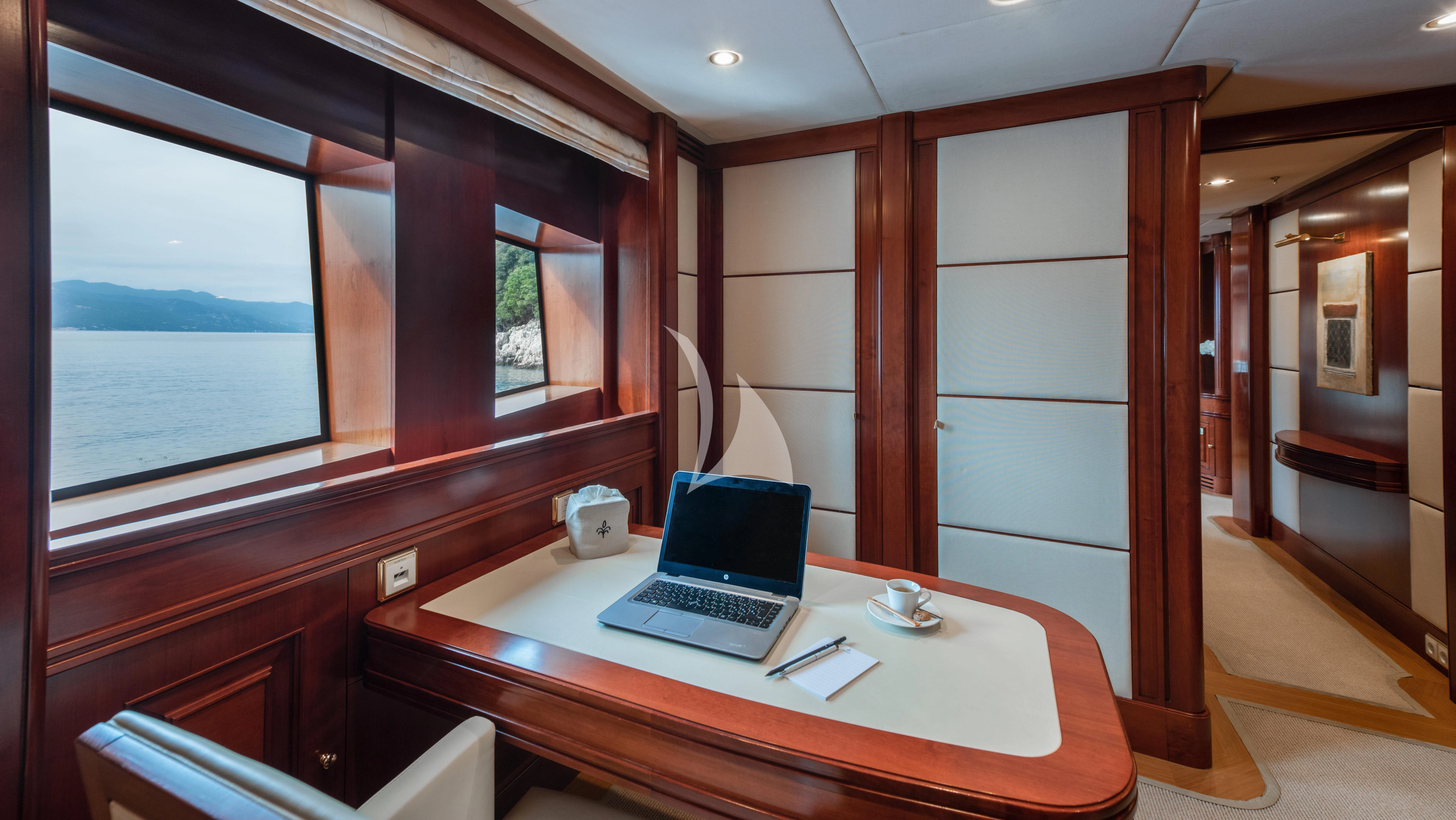 a laptop on a table aboard TIREA Yacht for Sale