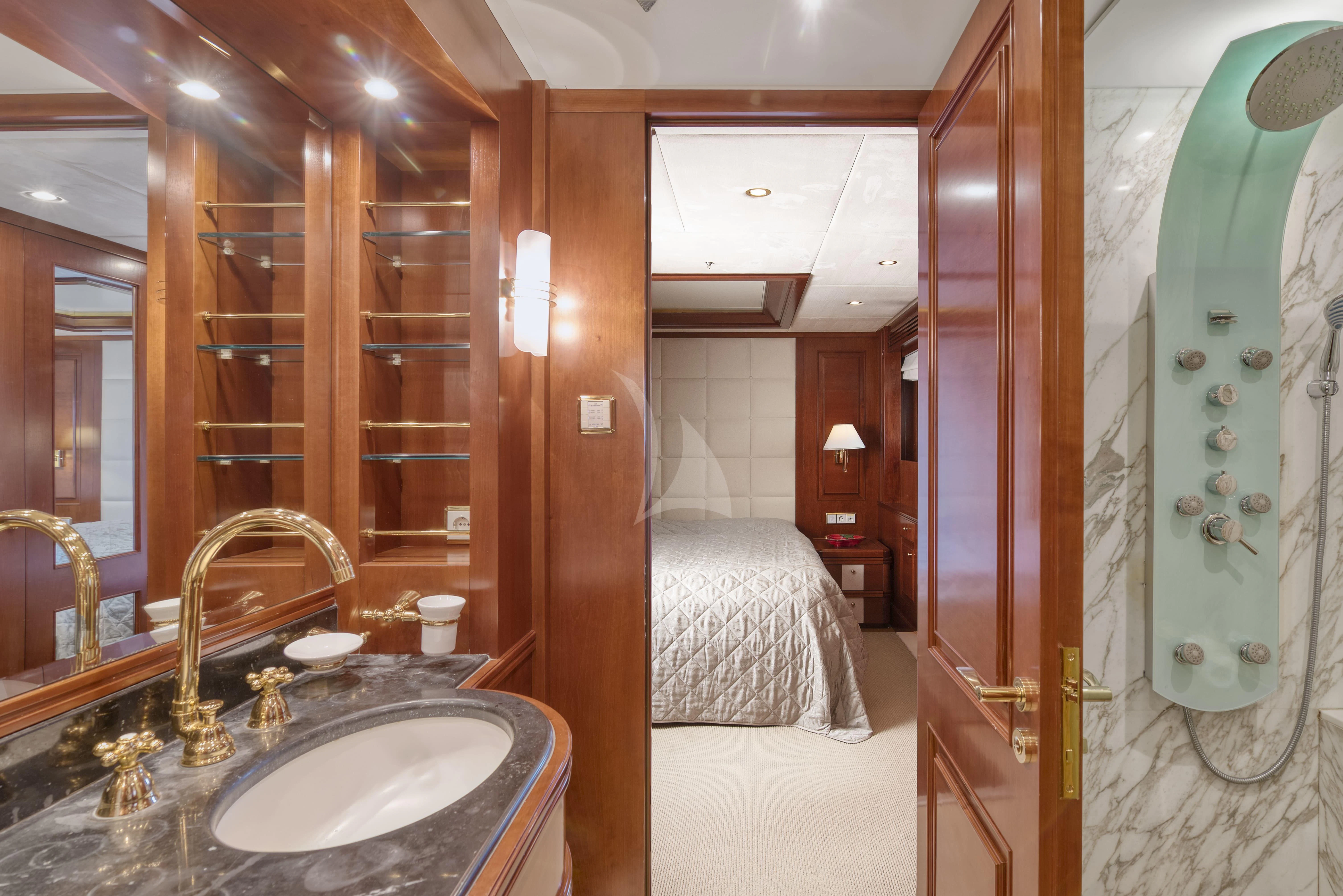 a bathroom with a sink and a bed aboard TIREA Yacht for Sale