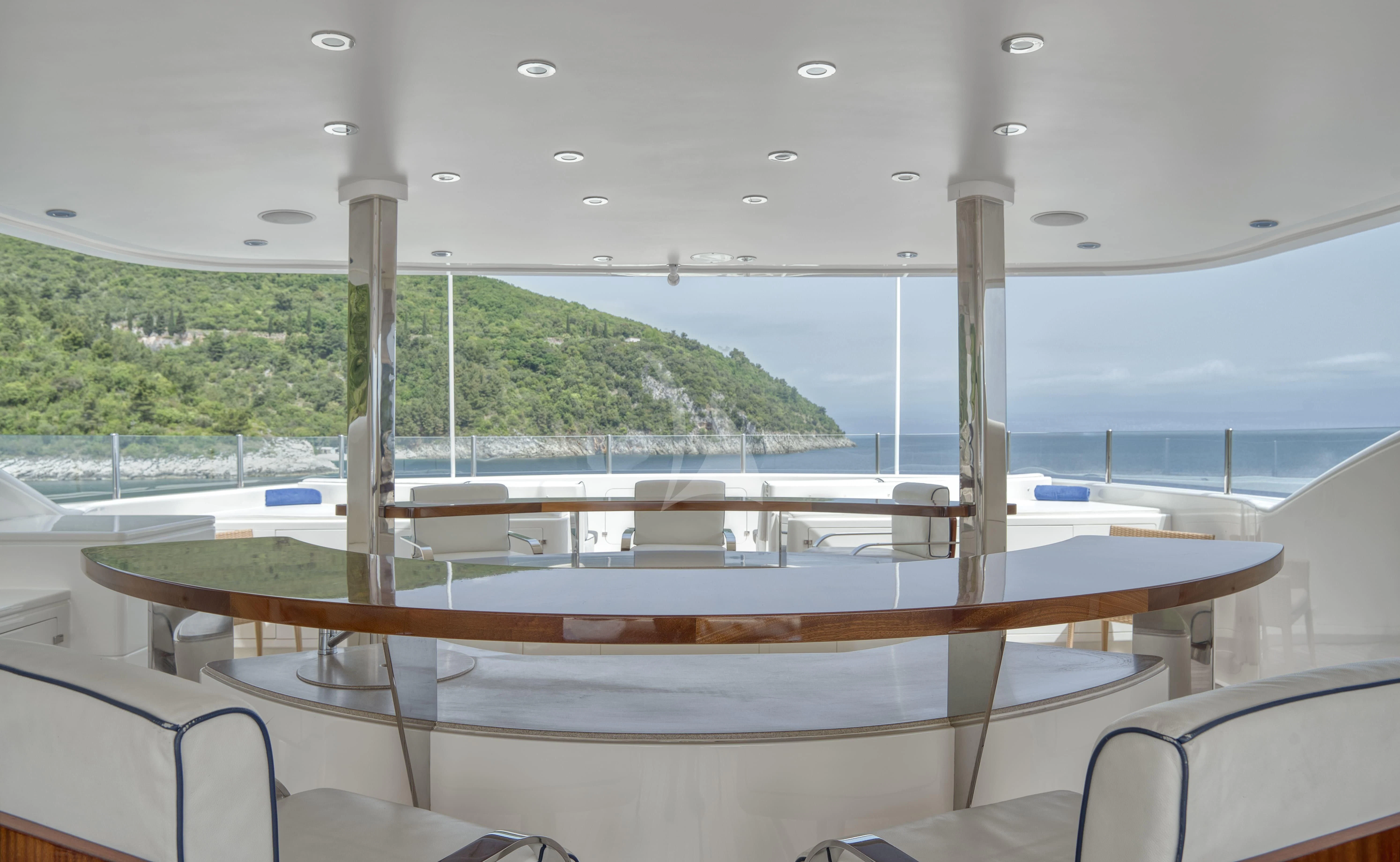 a deck with a view of a mountain and water aboard TIREA Yacht for Sale