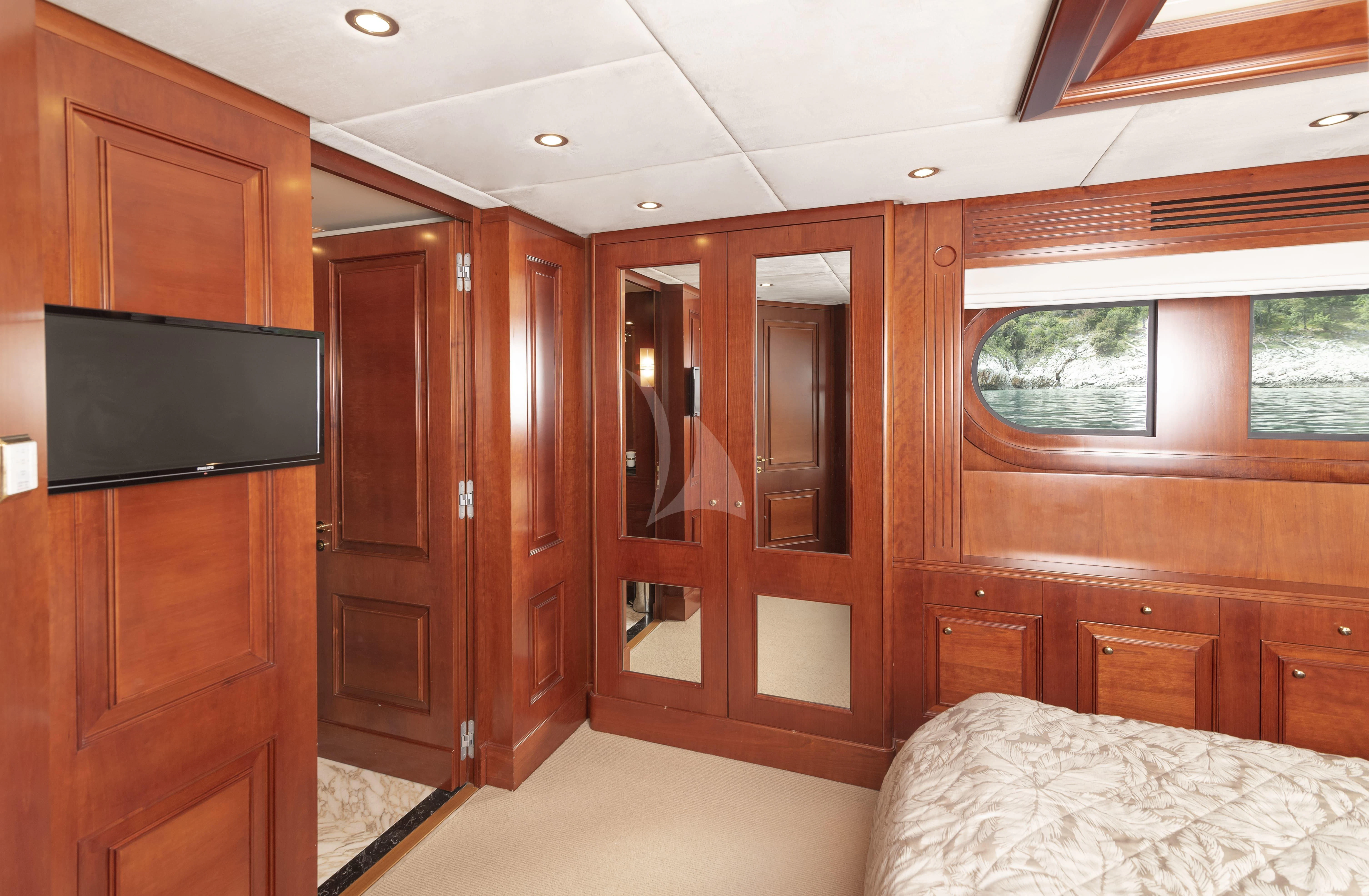 a room with a bed and a television aboard TIREA Yacht for Sale