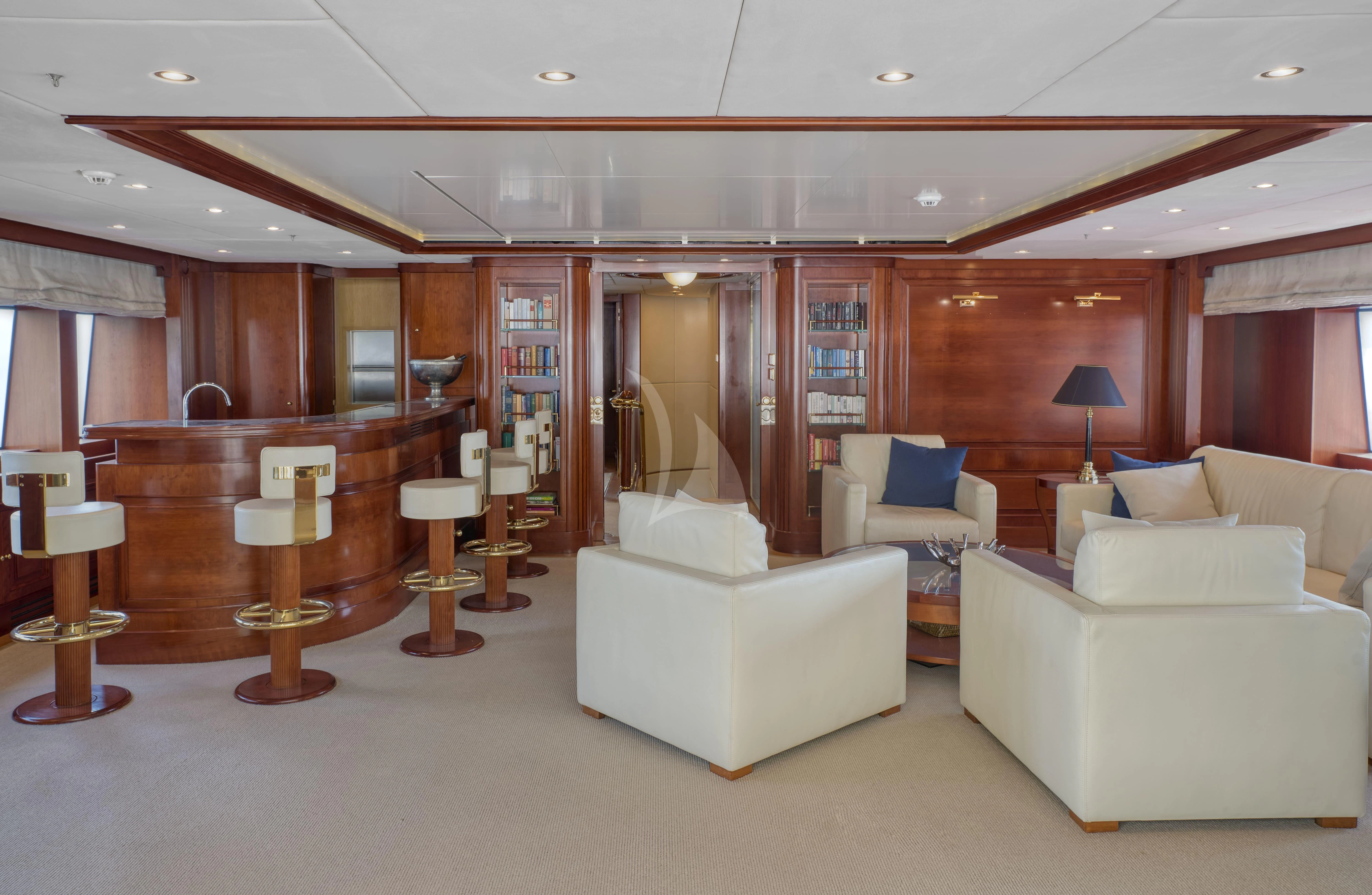 a large living room with white couches and a large mirror aboard TIREA Yacht for Sale