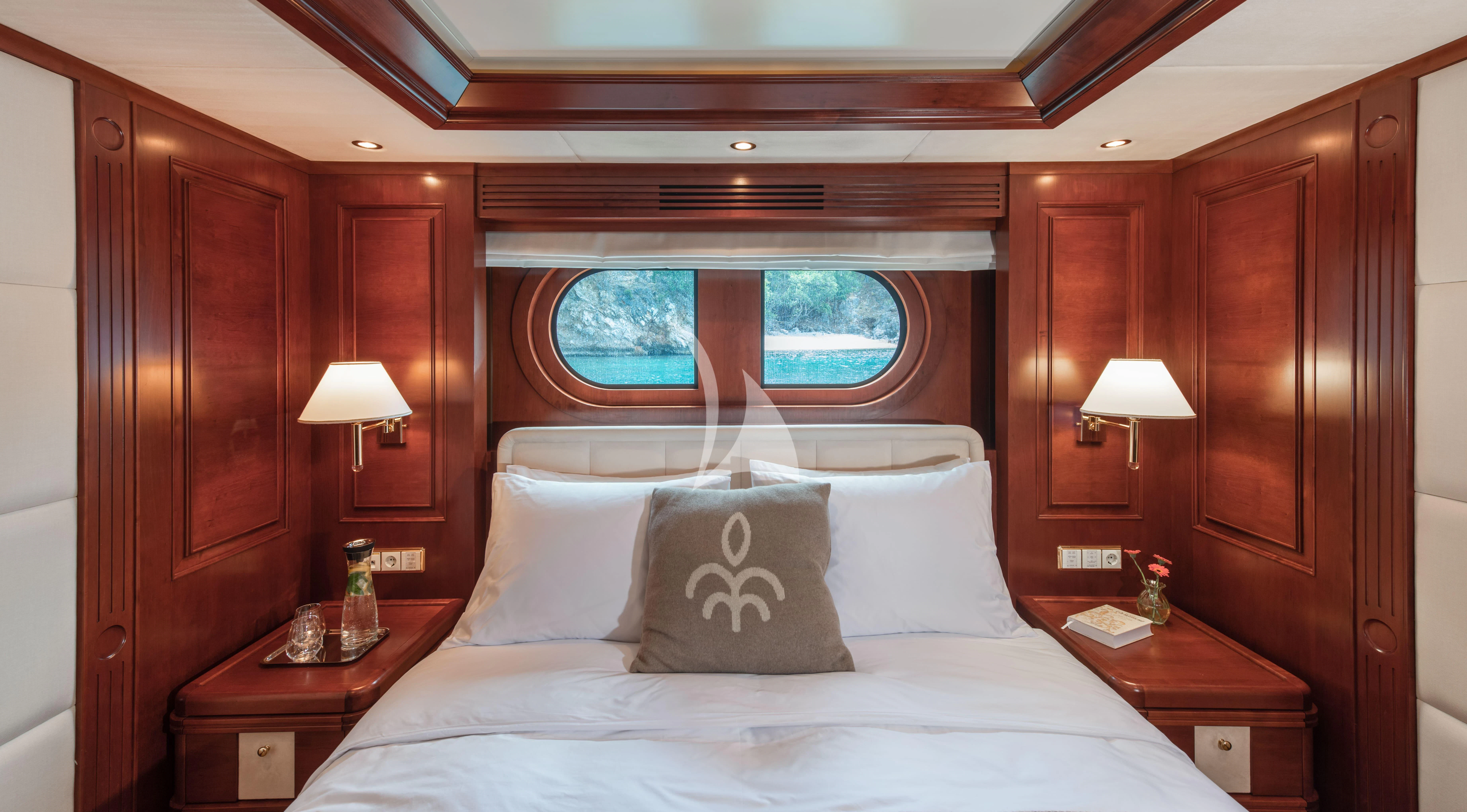 a bed with a white sheet and pillows aboard TIREA Yacht for Sale