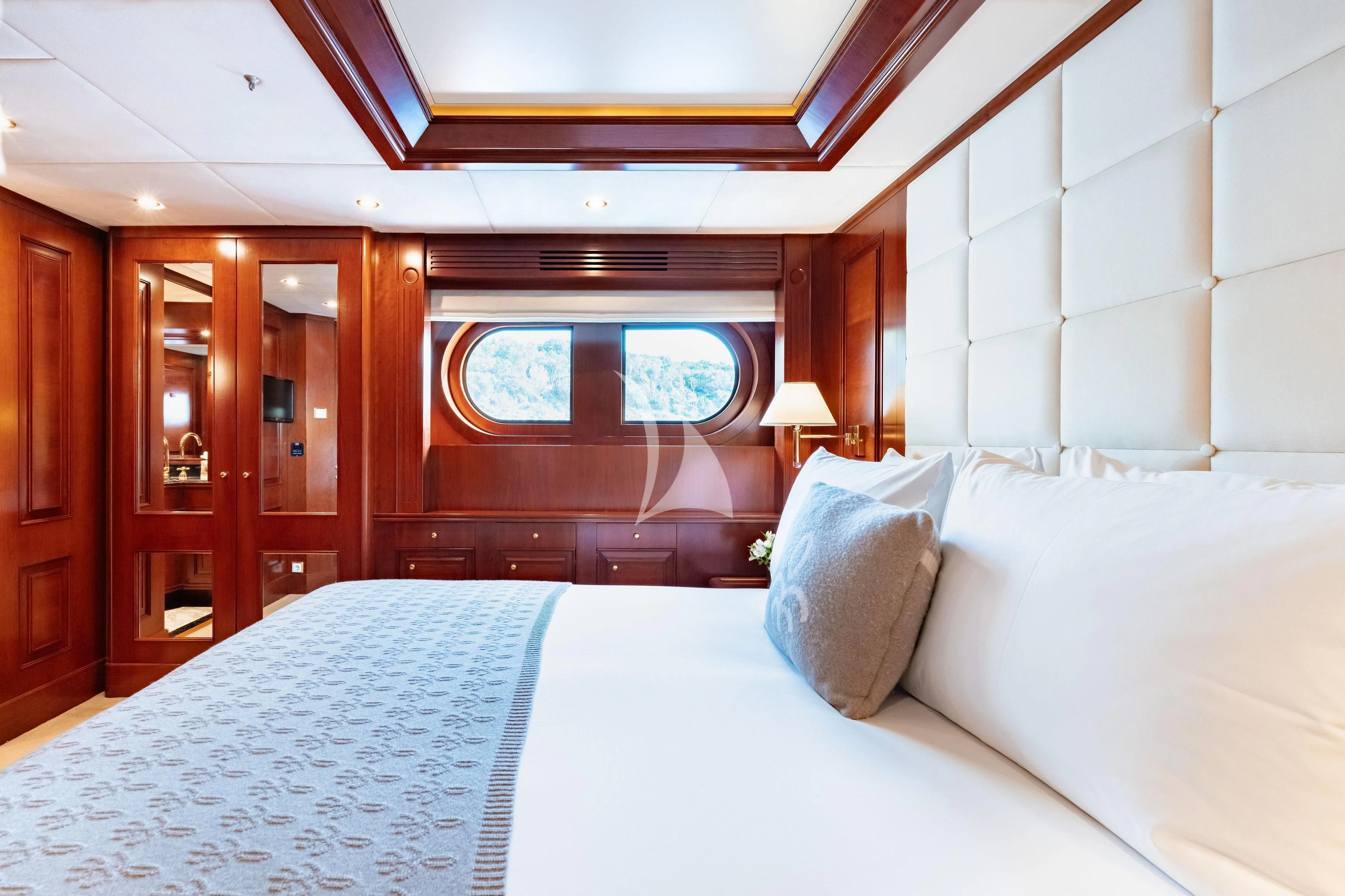 a room with a bed and a window aboard TIREA Yacht for Sale
