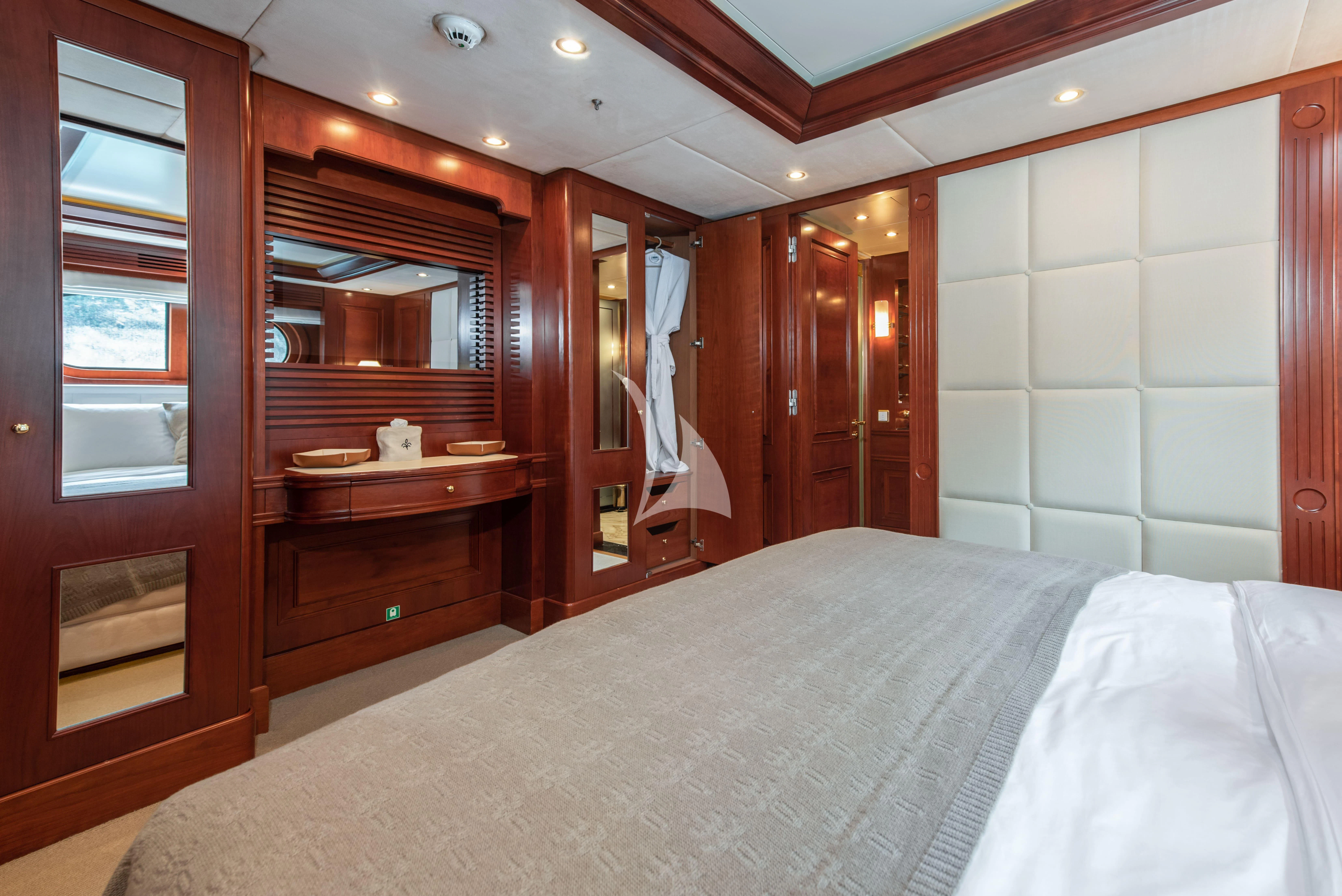 a bedroom with a bed and a mirror aboard TIREA Yacht for Sale