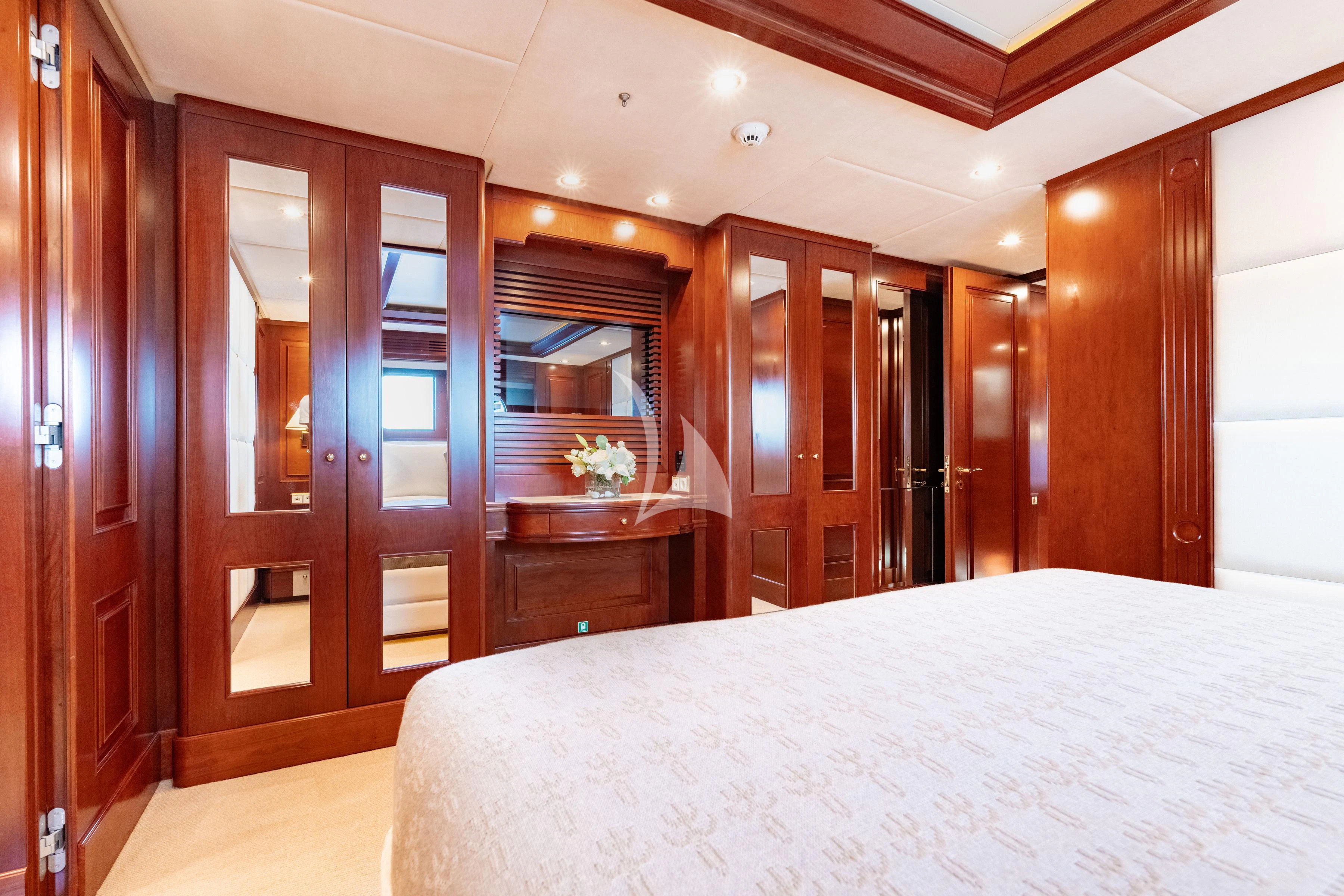 a bedroom with a bed and a closet aboard TIREA Yacht for Sale