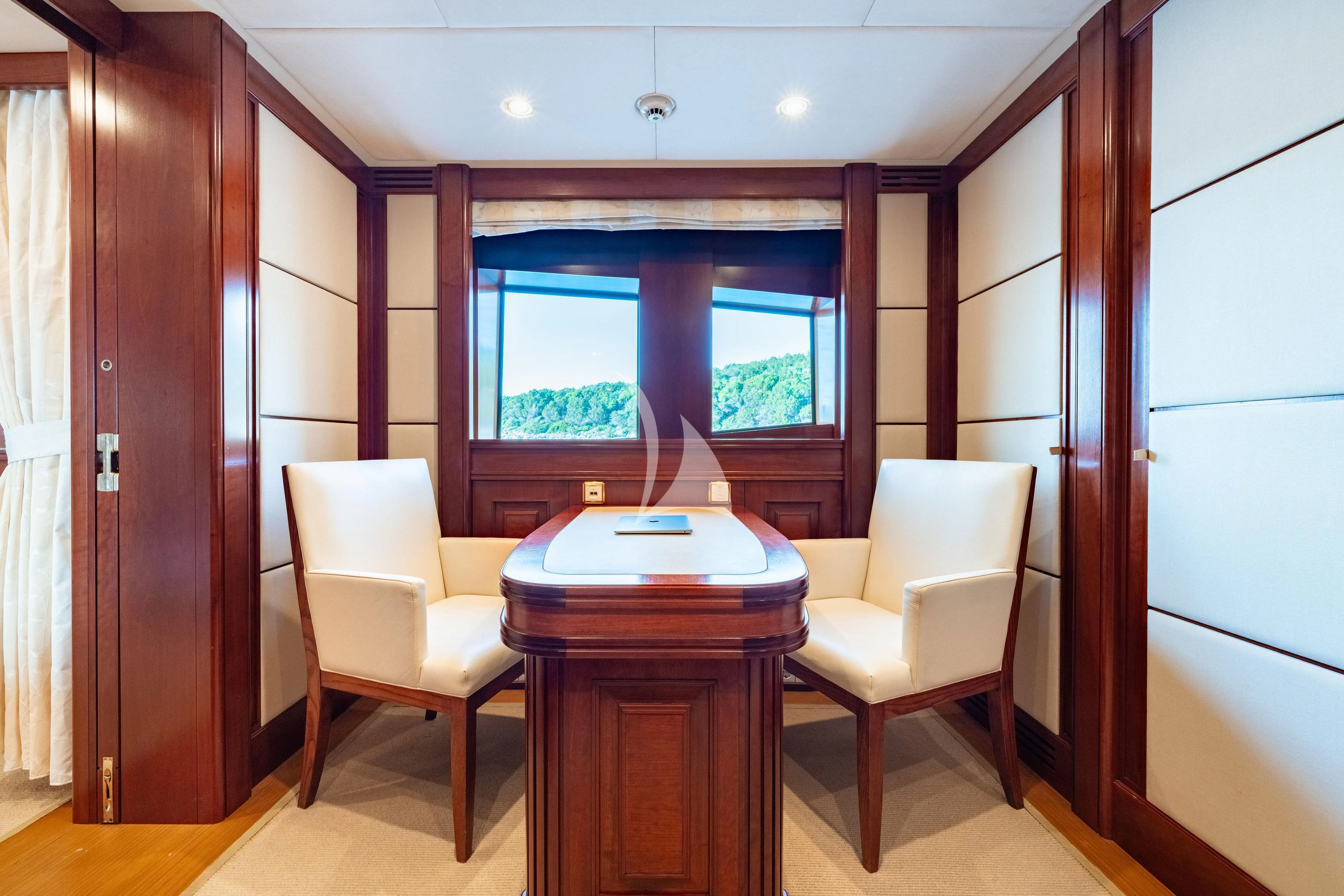 a room with a table and chairs aboard TIREA Yacht for Sale