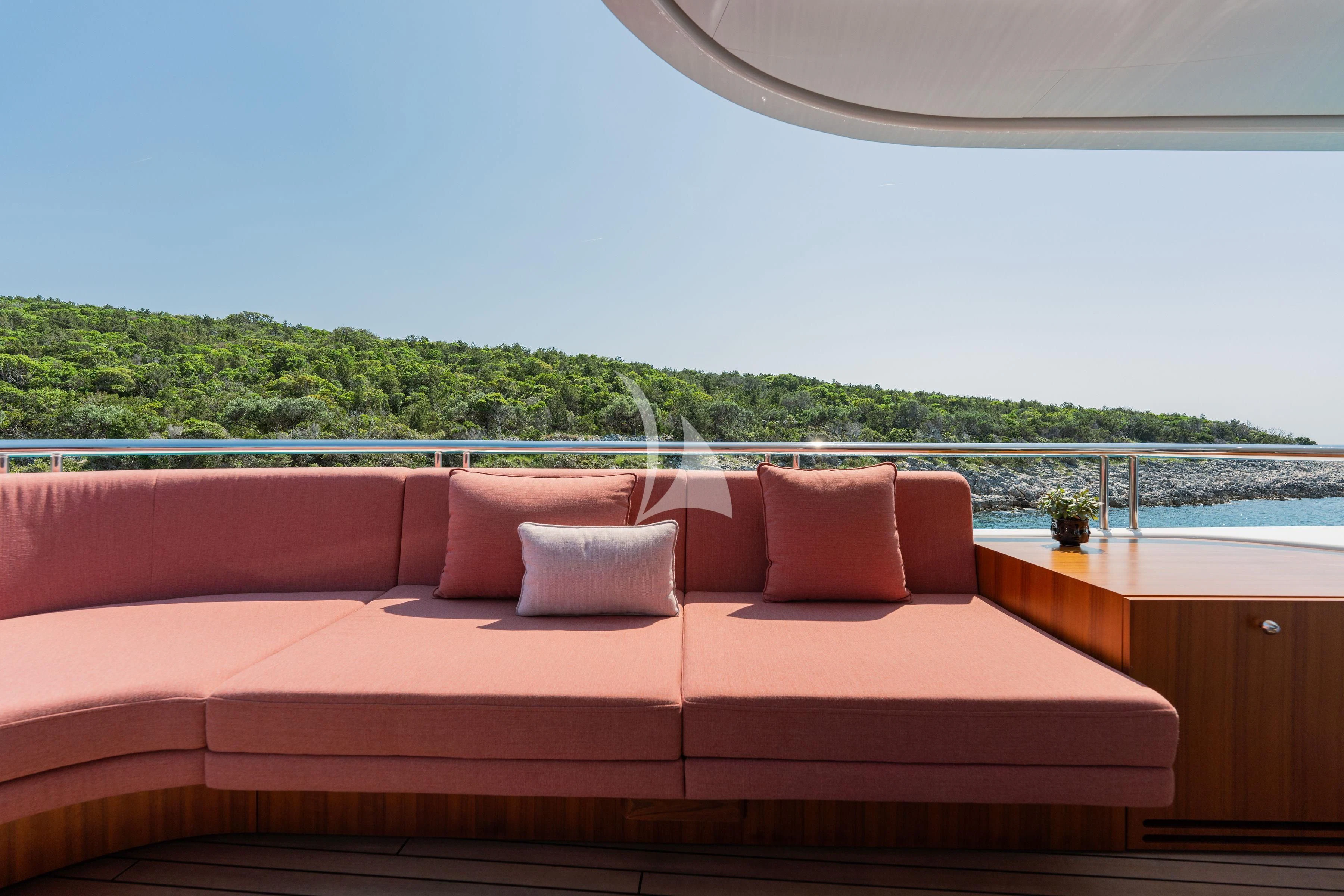 a couch with a table and a window aboard TIREA Yacht for Sale