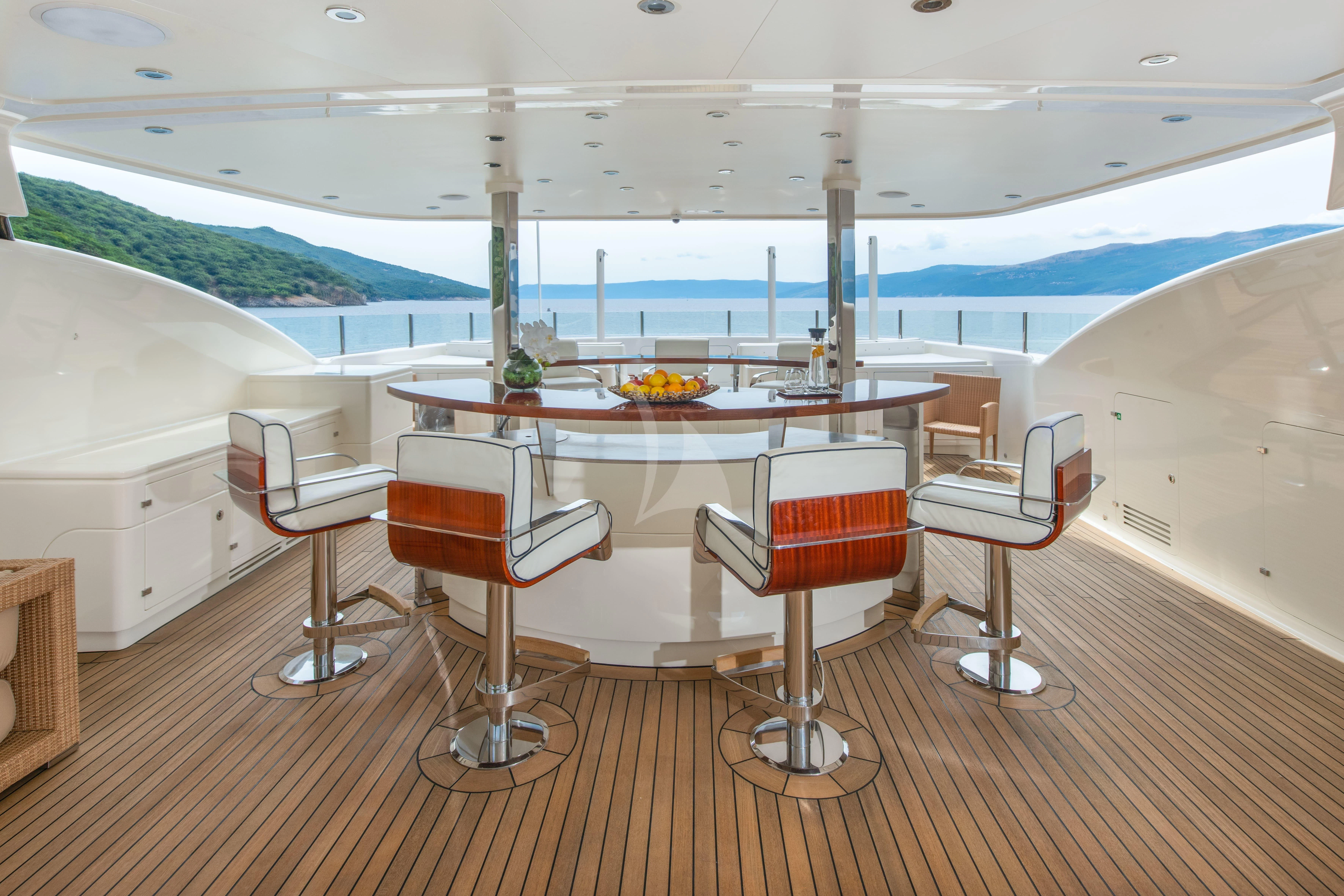 a table and chairs in a room aboard TIREA Yacht for Sale