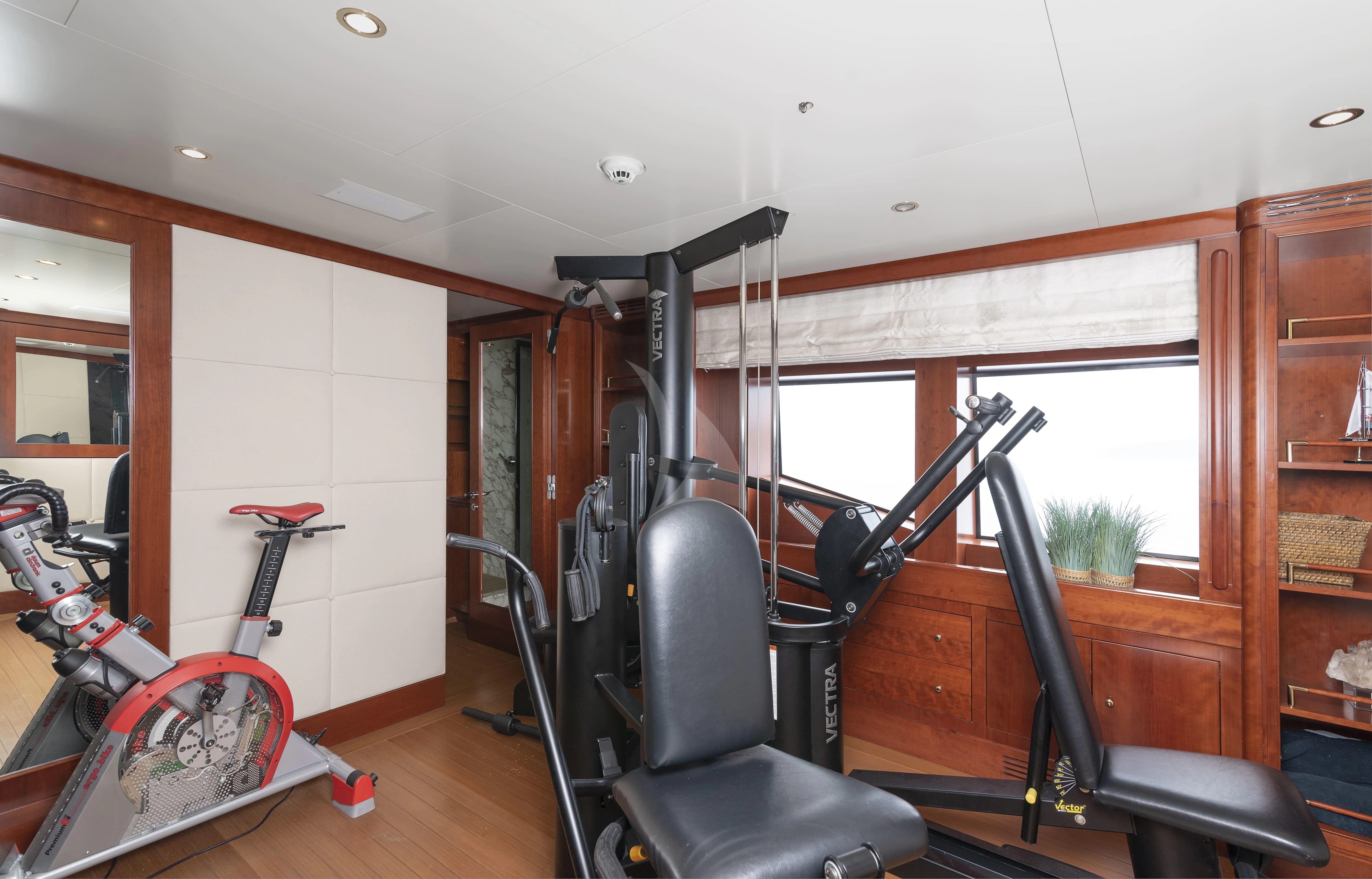 a room with a bicycle and a chair aboard TIREA Yacht for Sale