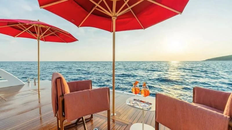a table and chairs on a beach aboard TIREA Yacht for Sale