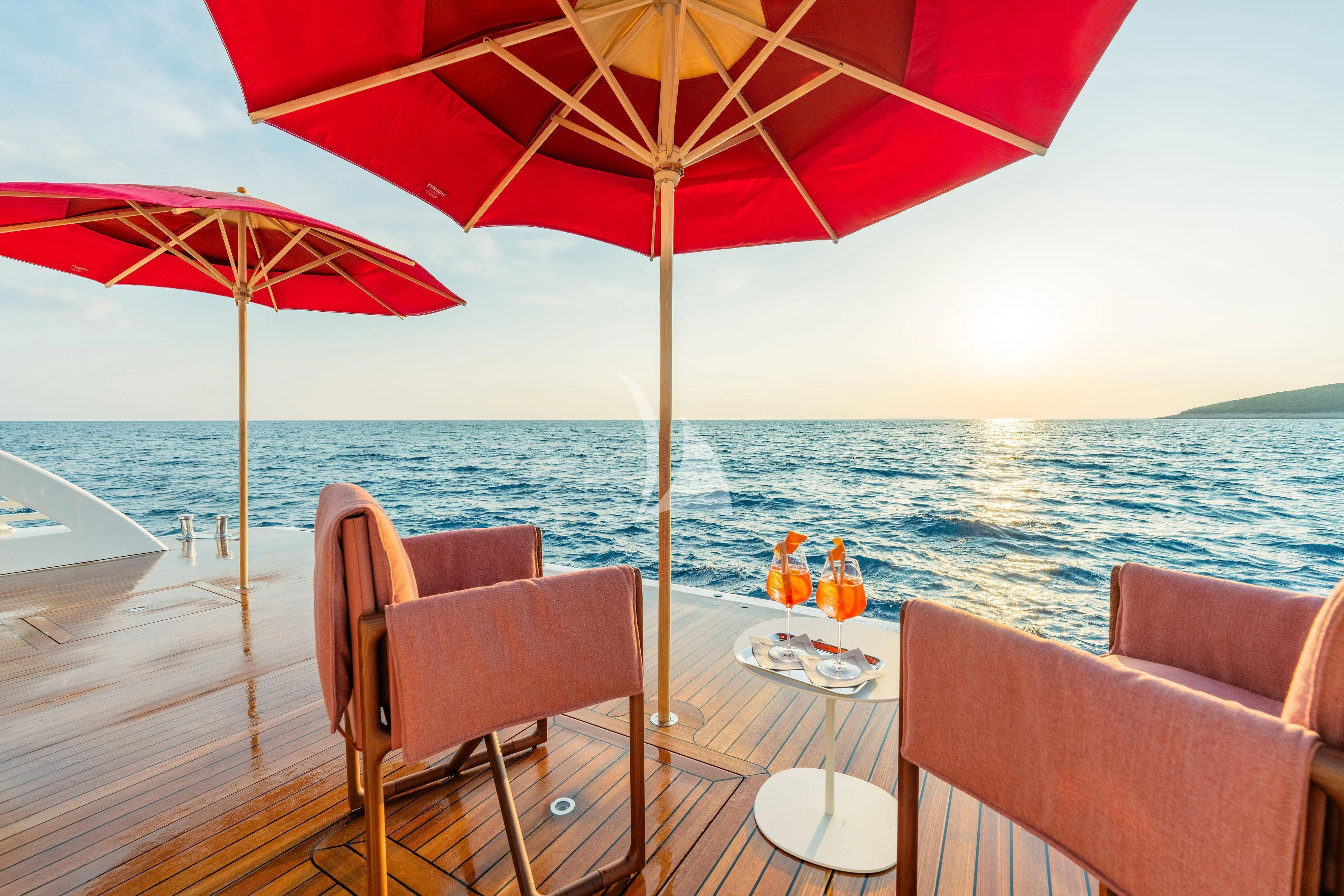 a table with umbrellas on it aboard TIREA Yacht for Sale
