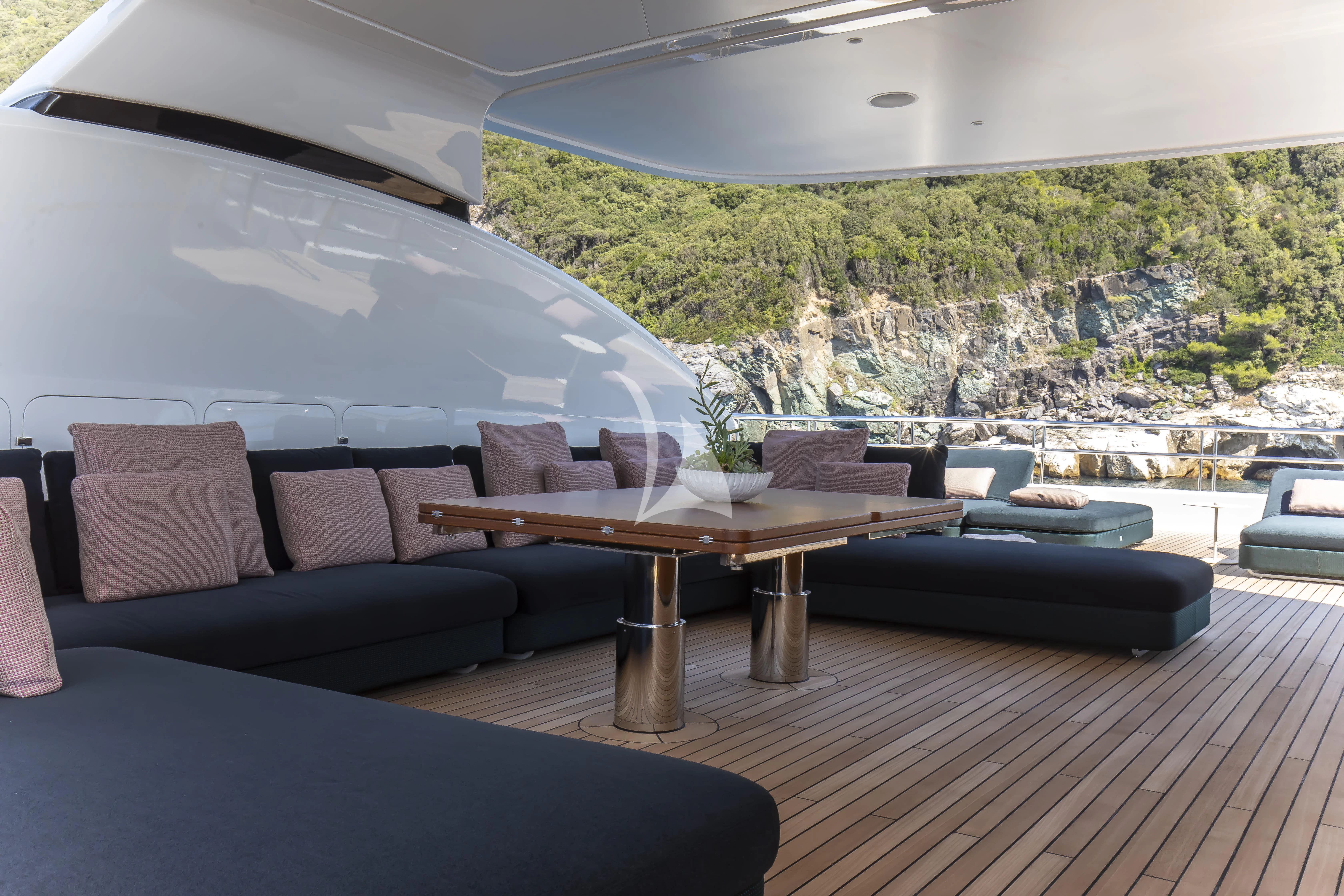 a room with a table and couches aboard TIREA Yacht for Sale