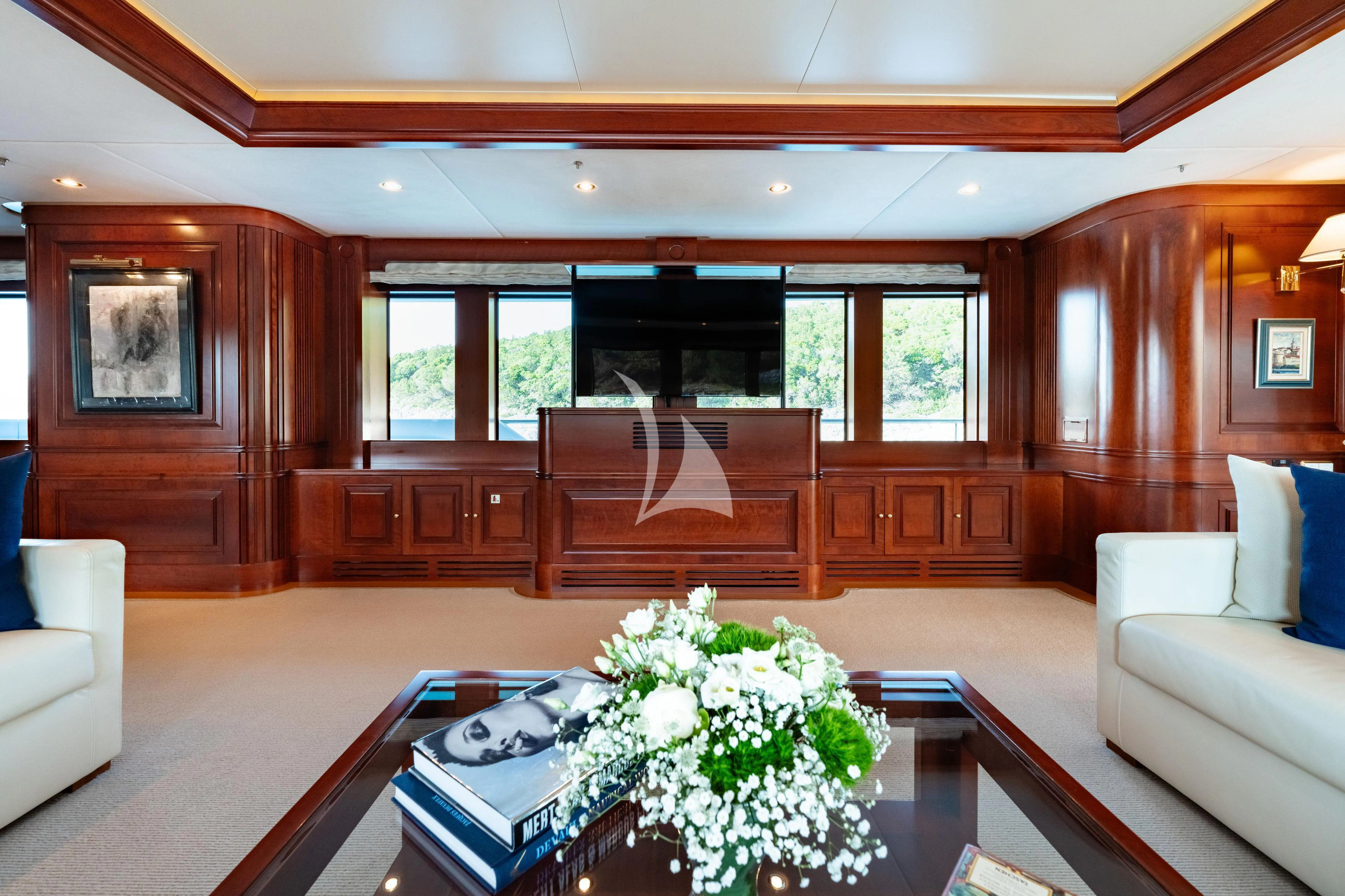 a living room with wood furniture aboard TIREA Yacht for Sale