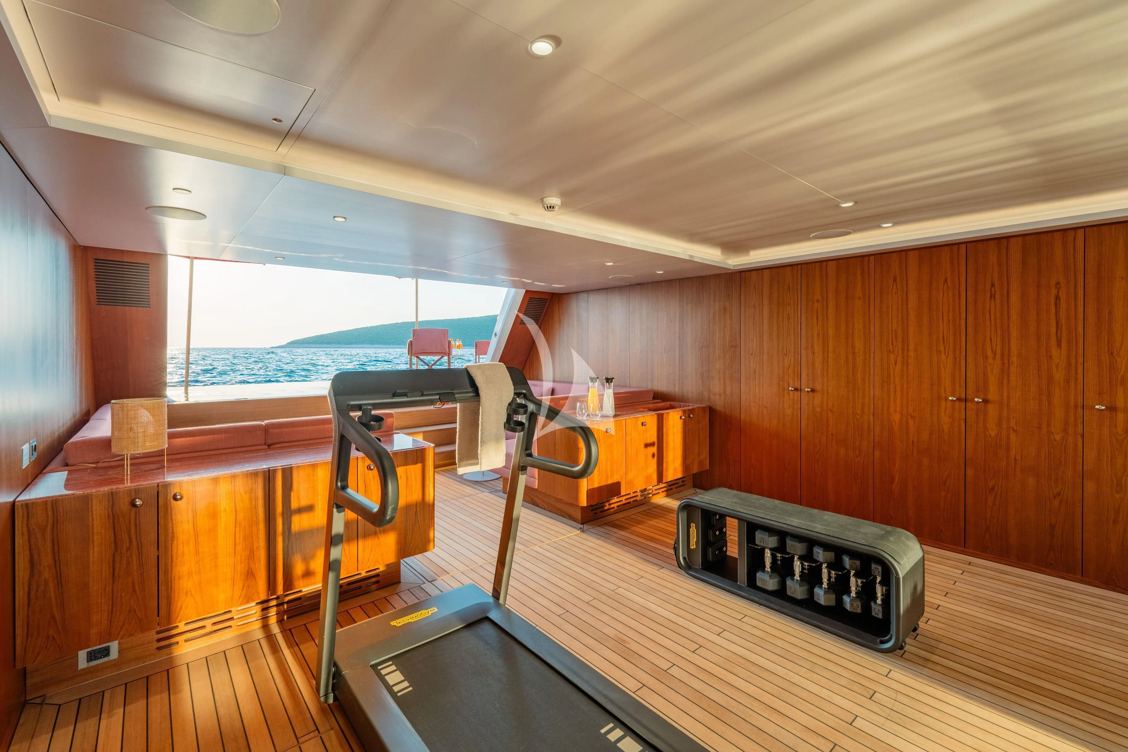a room with a large window and a table with a large computer on it aboard TIREA Yacht for Sale