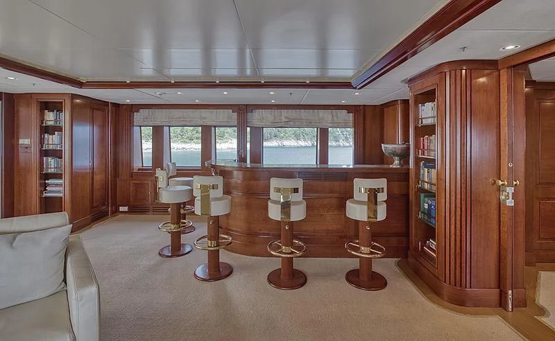 a room with a few chairs and a table with chairs aboard TIREA Yacht for Sale