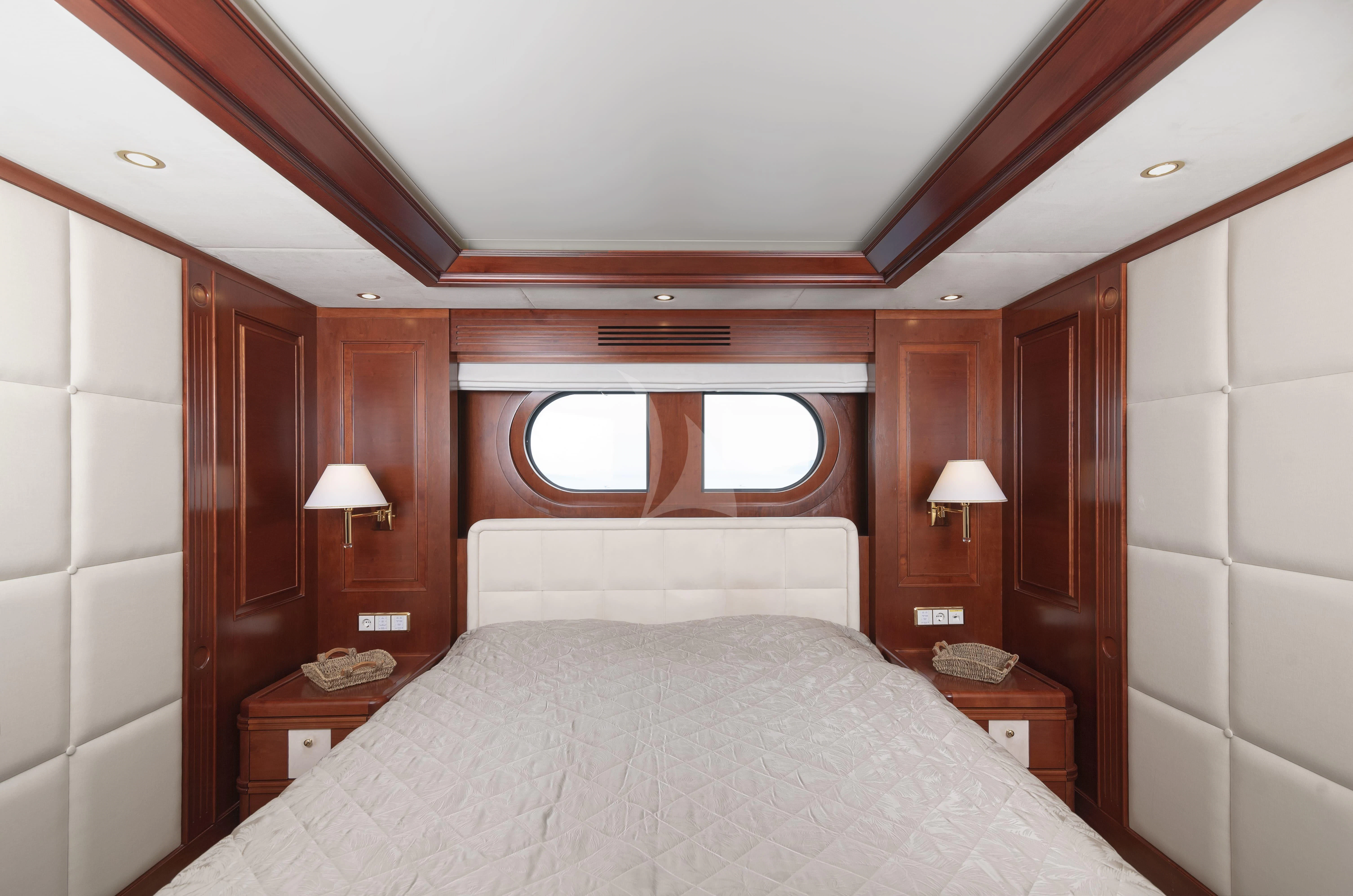 a bedroom with a bed and a window aboard TIREA Yacht for Sale