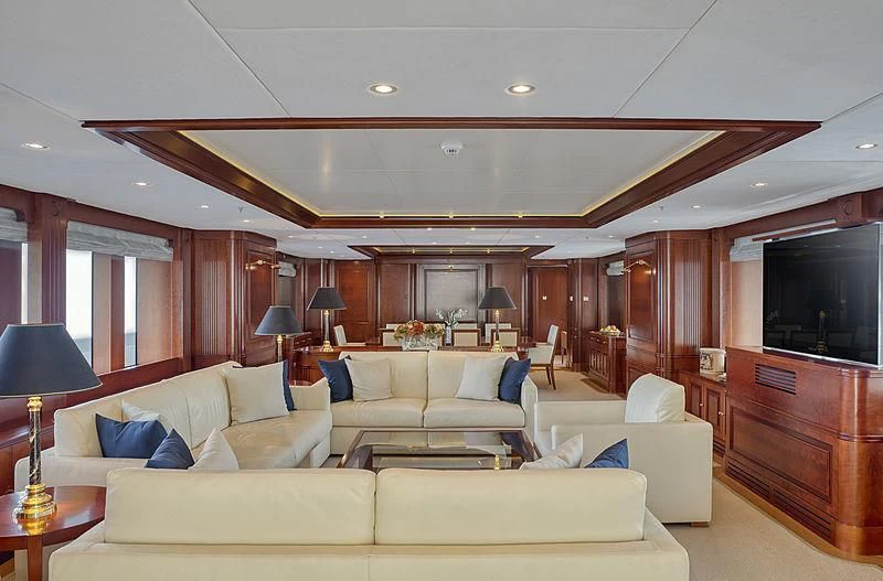 a living room with a large white sofa and a television aboard TIREA Yacht for Sale