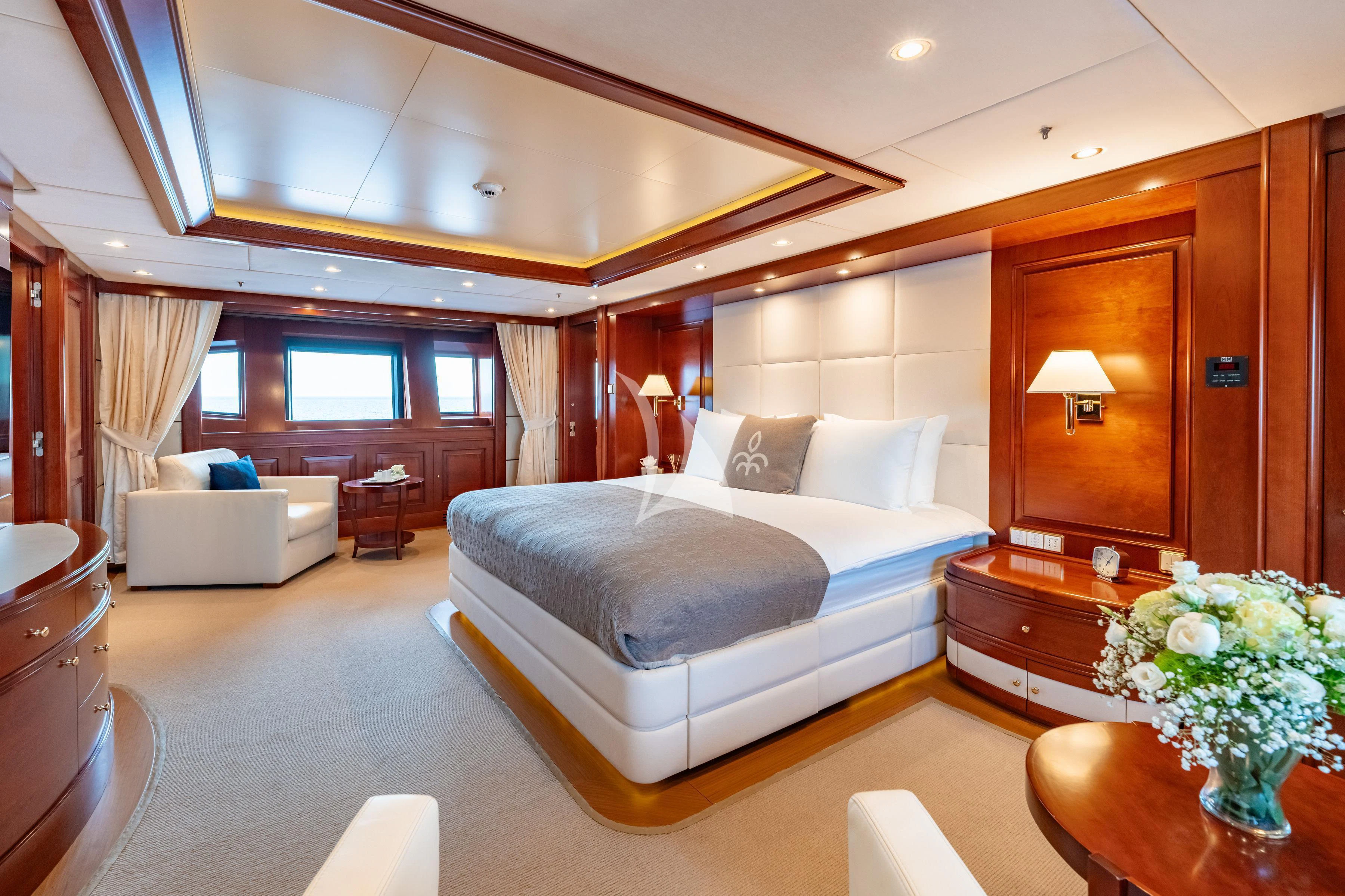 a bedroom with a bed and a couch aboard TIREA Yacht for Sale