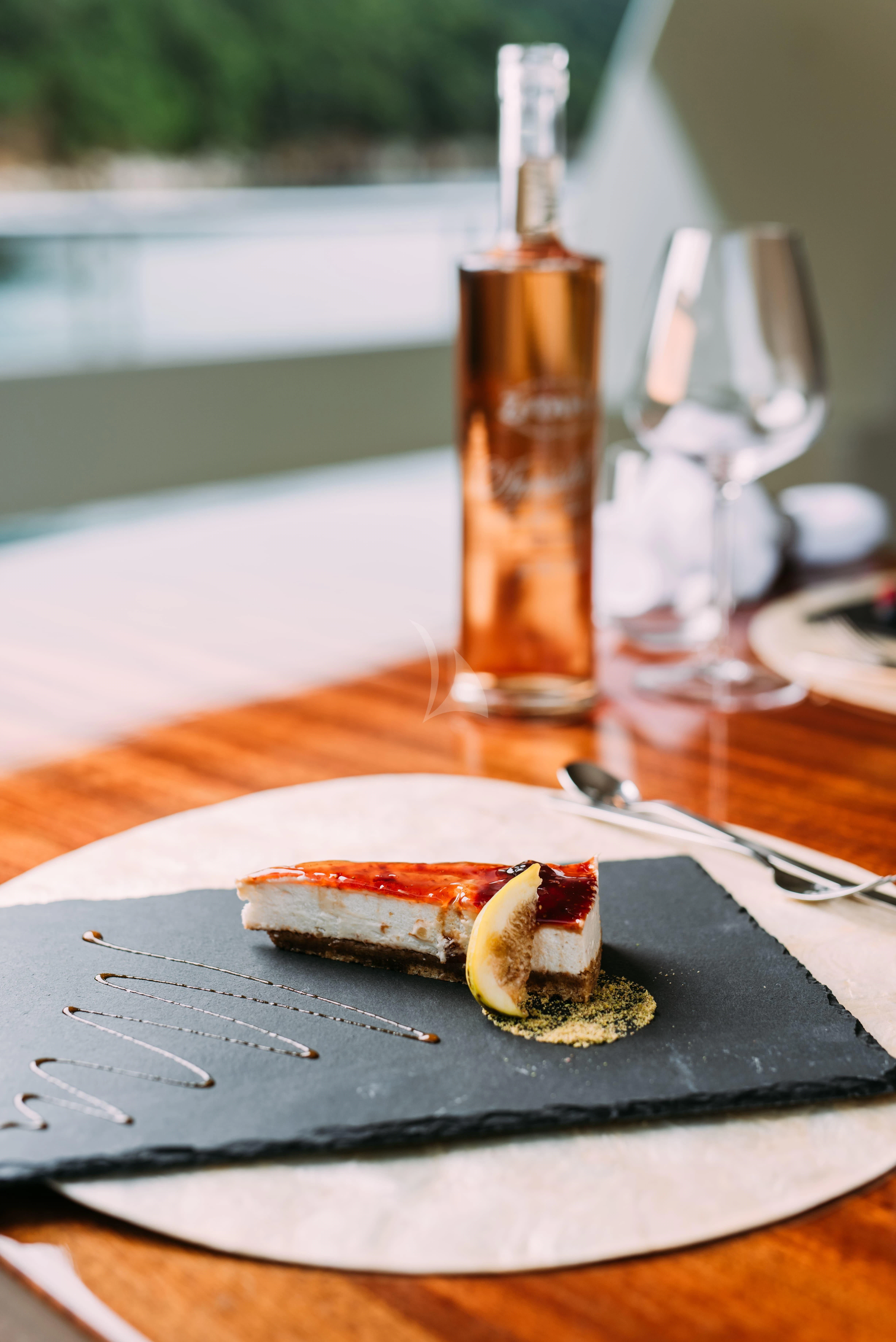 a plate with a hot dog and a bottle of beer on it aboard TIREA Yacht for Sale