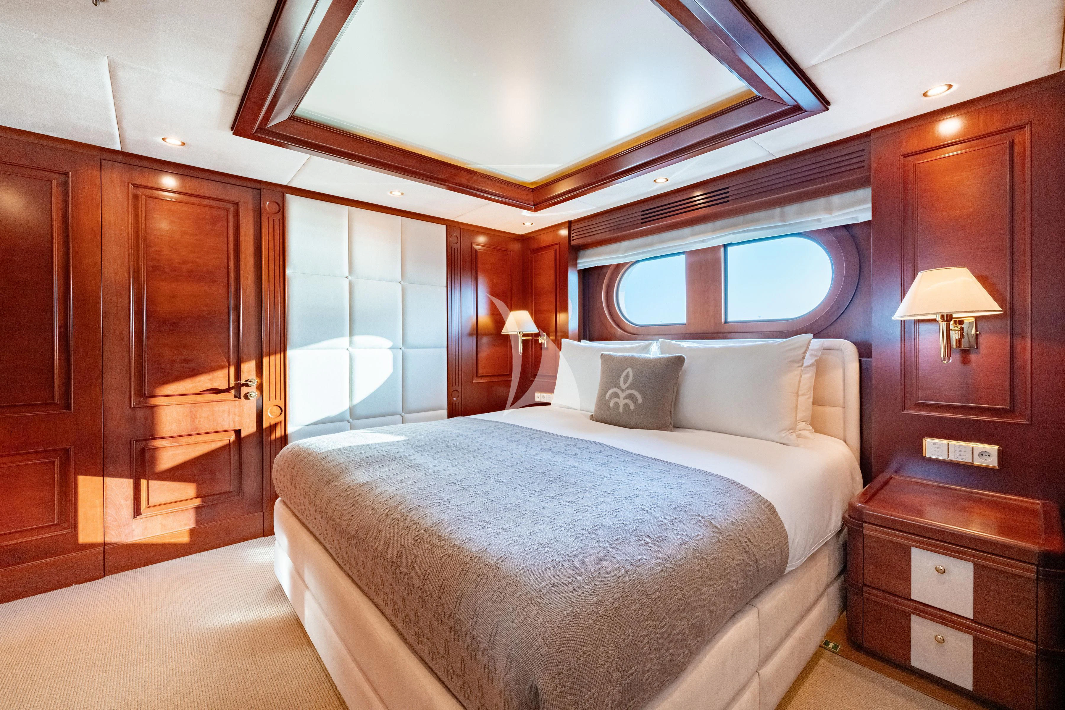 a bedroom with a bed and a dresser aboard TIREA Yacht for Sale