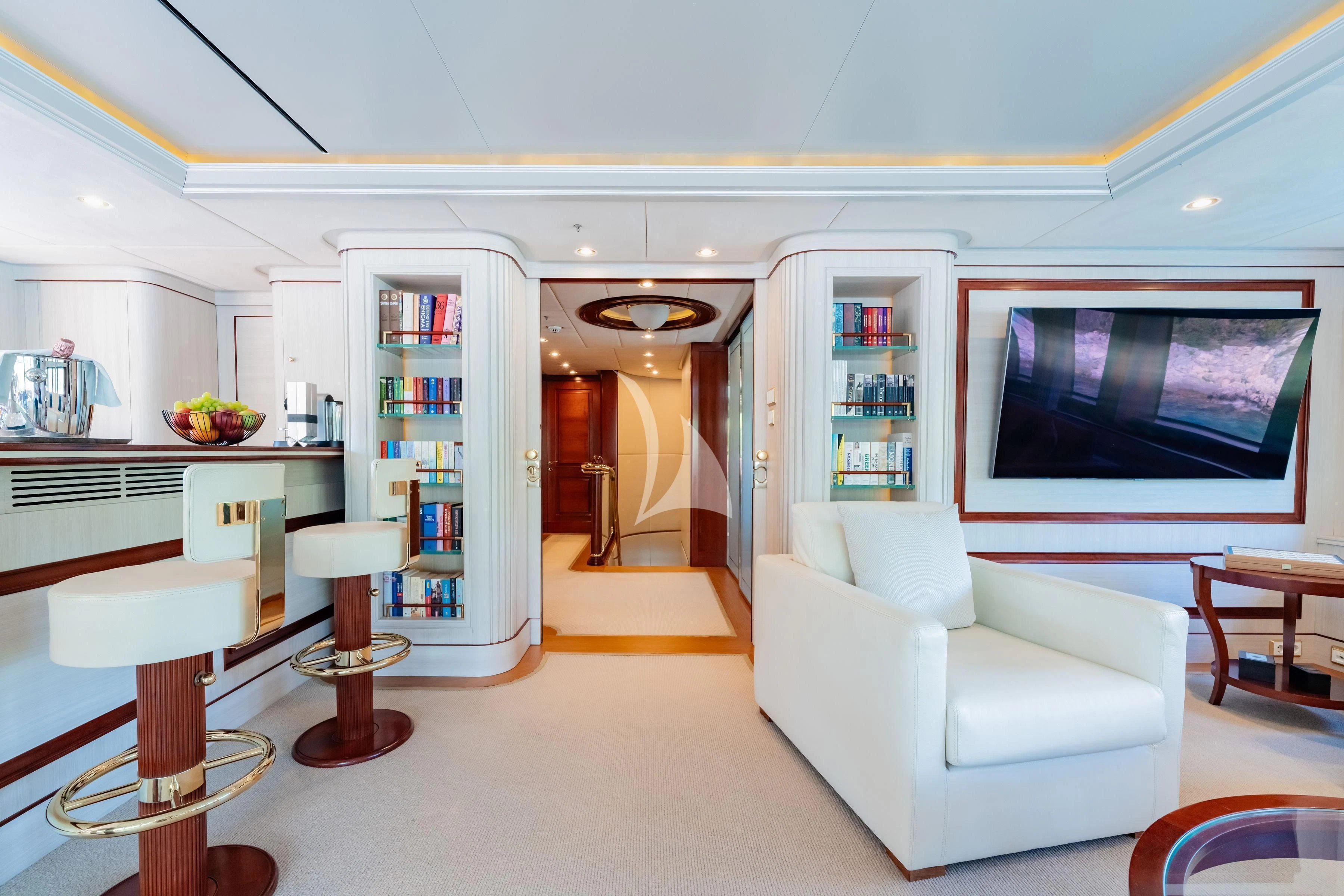 a living room with a white couch and a tv aboard TIREA Yacht for Sale