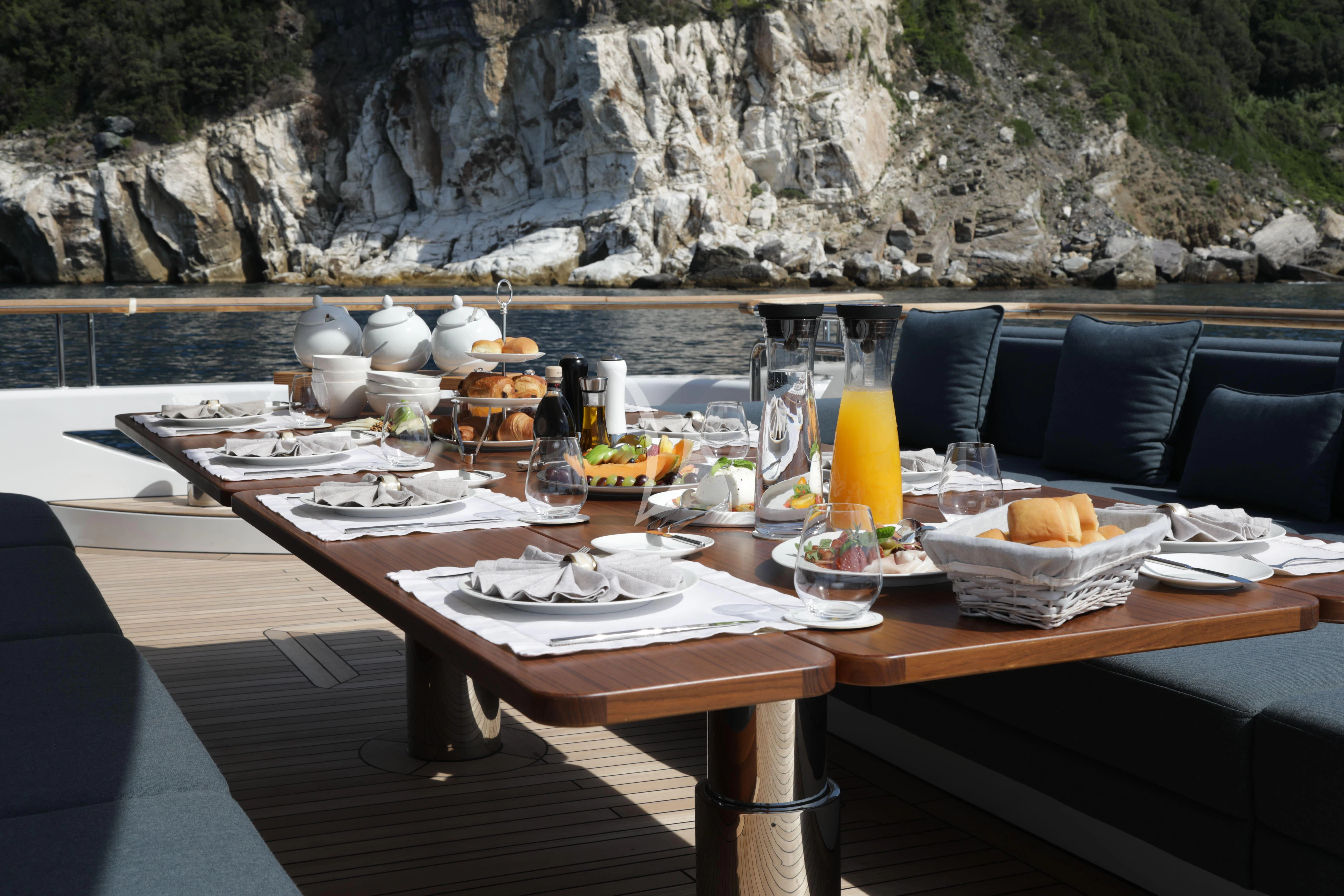 a table with food and drinks aboard TIREA Yacht for Sale