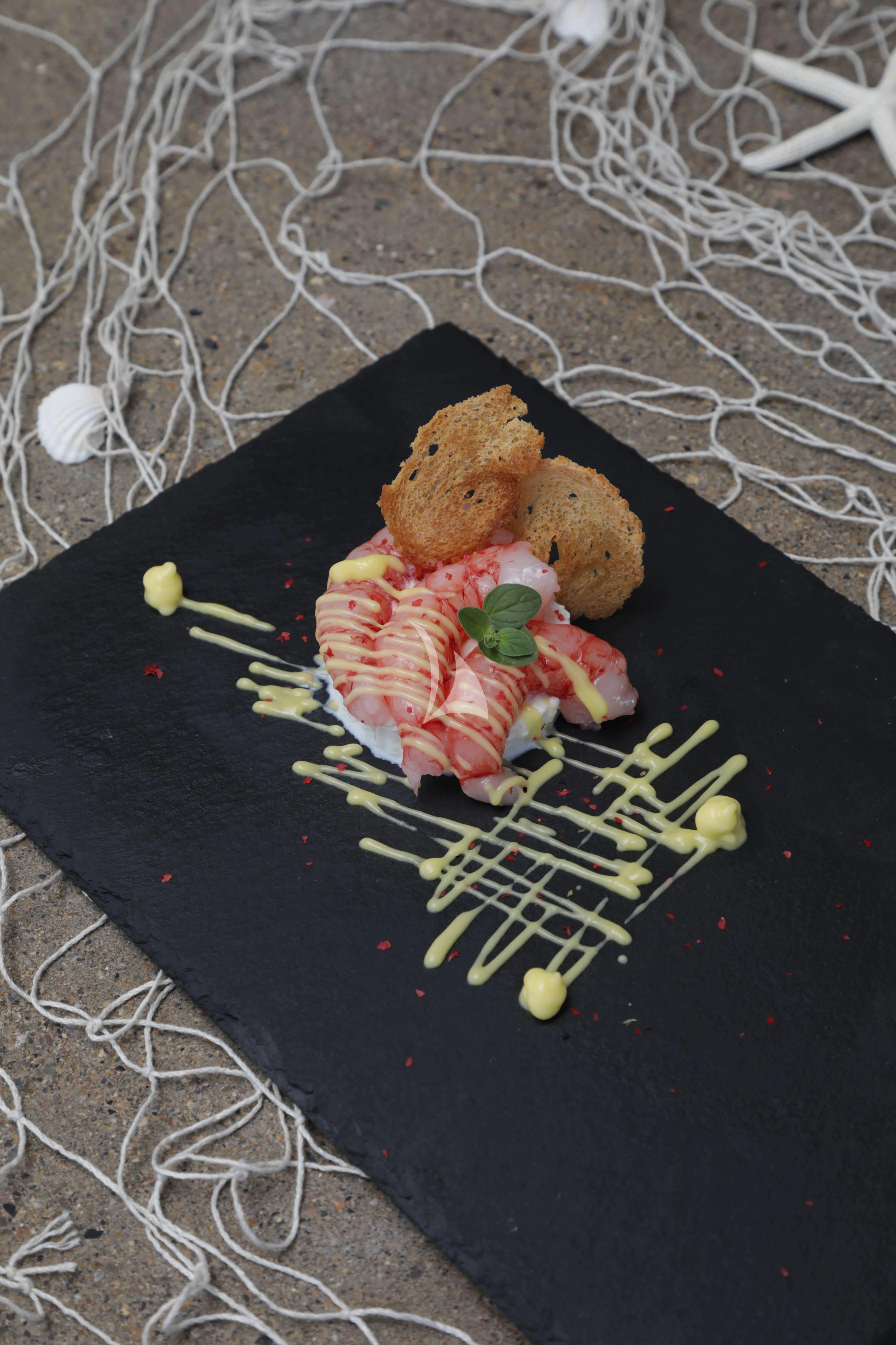 a plate of food aboard TIREA Yacht for Sale