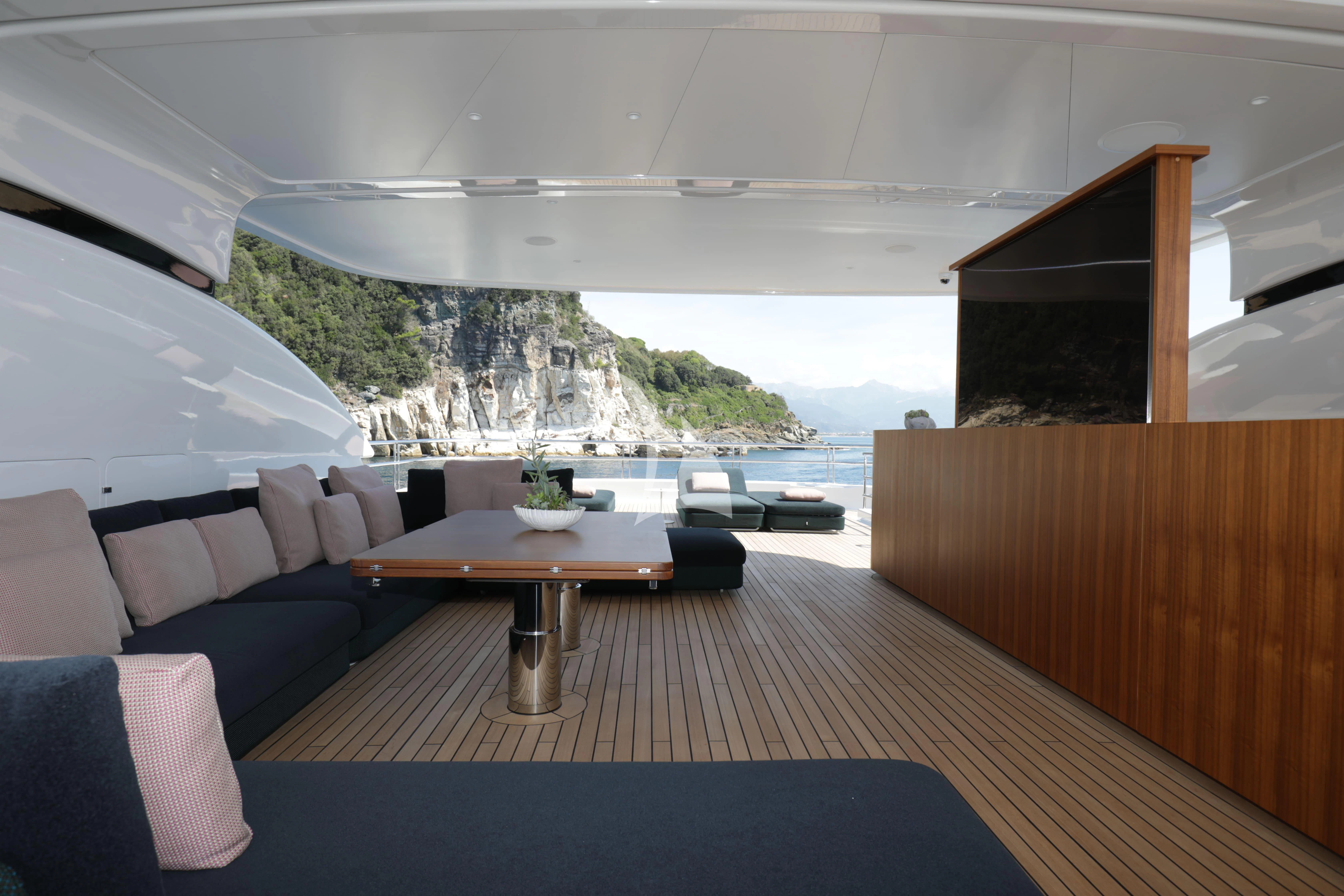 a room with a couch and a table and a large window aboard TIREA Yacht for Sale