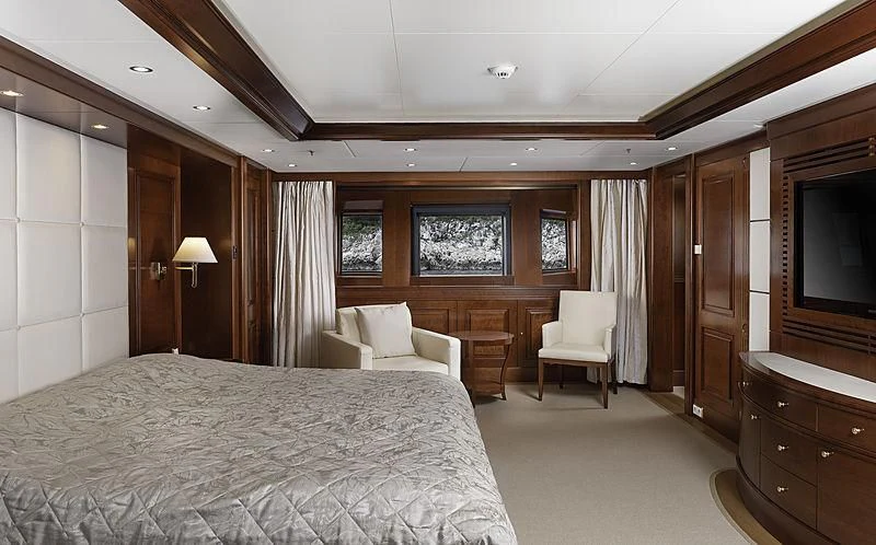 a bedroom with a bed and a television aboard TIREA Yacht for Sale