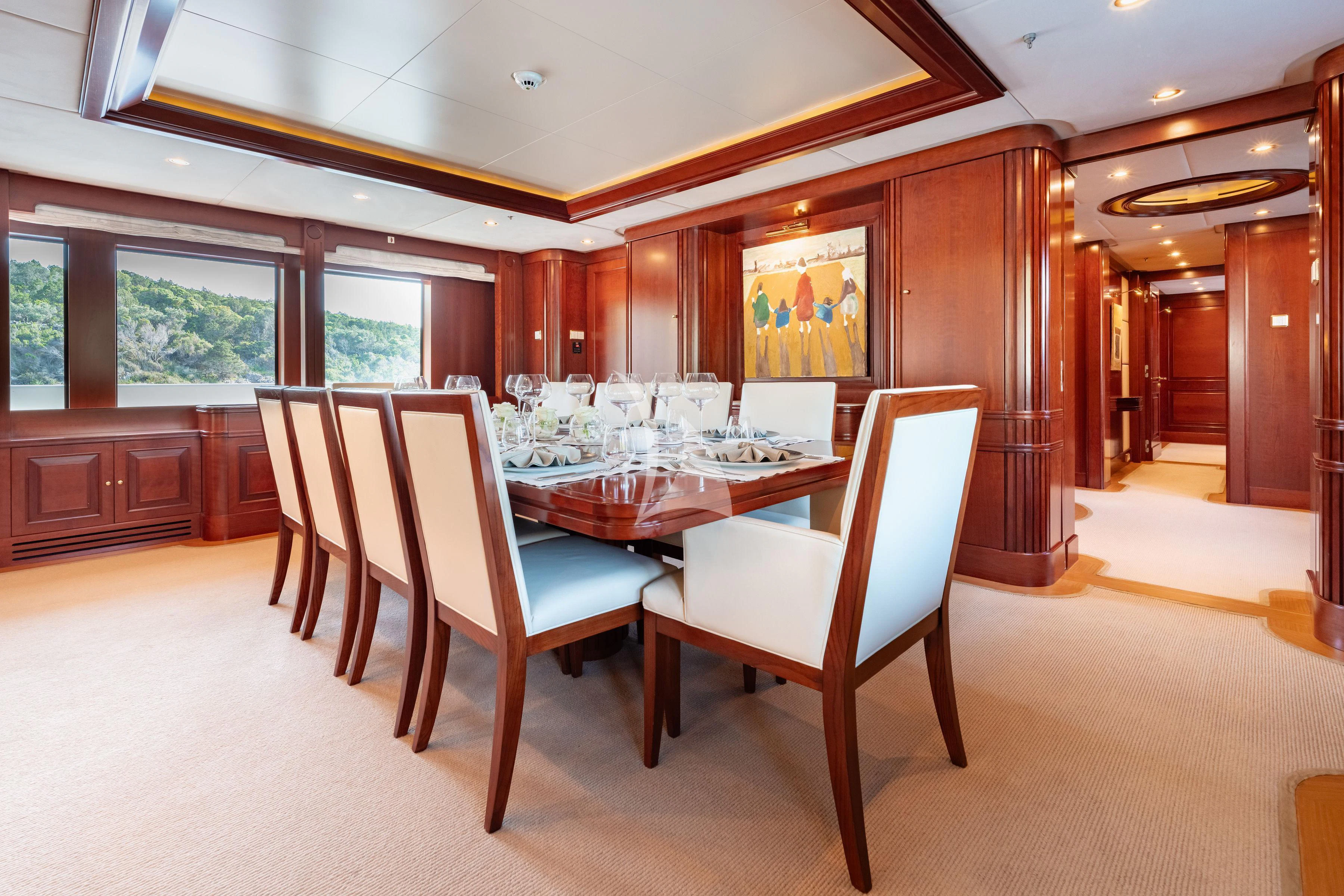 a dining room with a table and chairs aboard TIREA Yacht for Sale