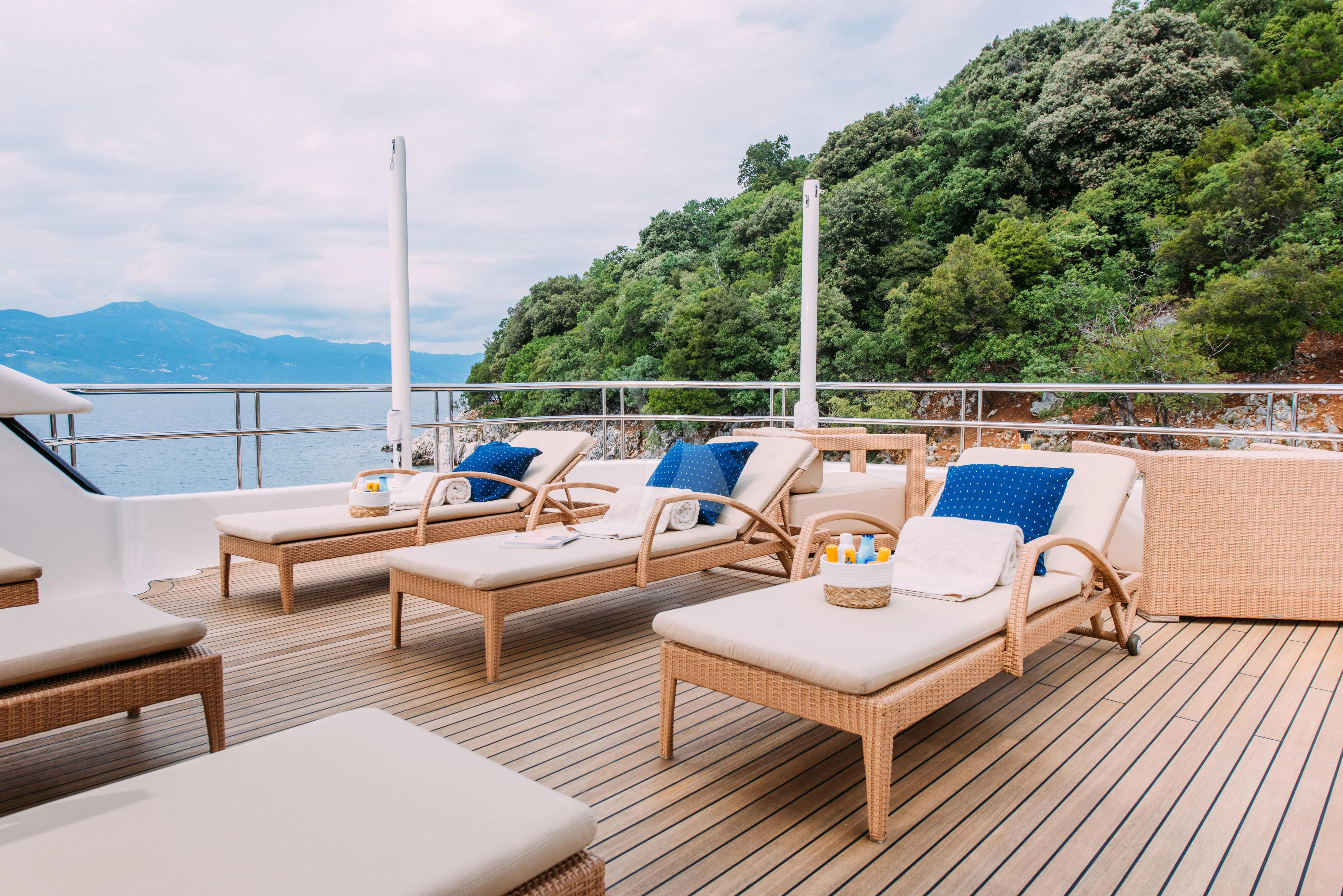 a deck with chairs and tables on it aboard TIREA Yacht for Sale