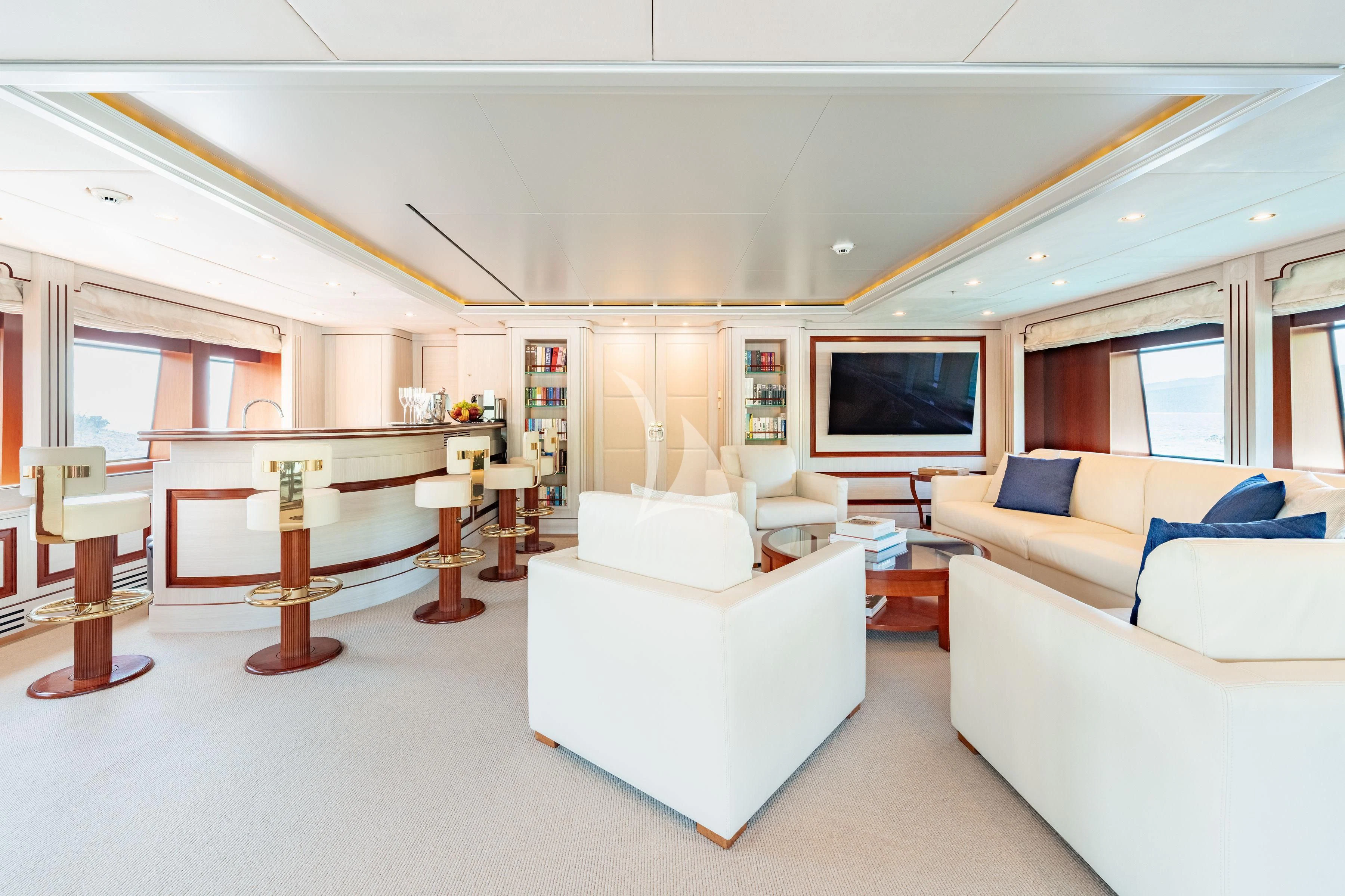 a living room with white furniture aboard TIREA Yacht for Sale