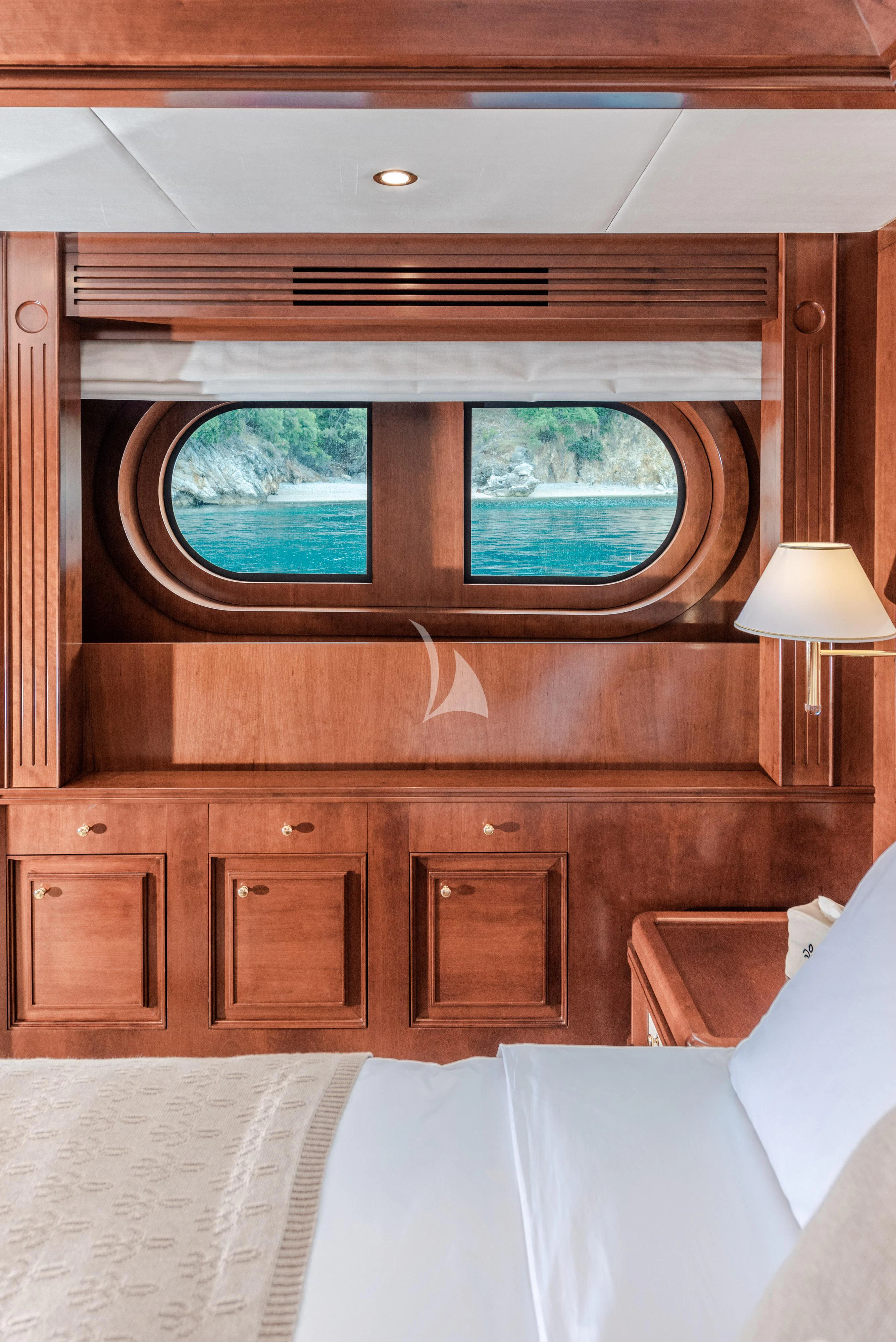 a room with a bed and a window aboard TIREA Yacht for Sale
