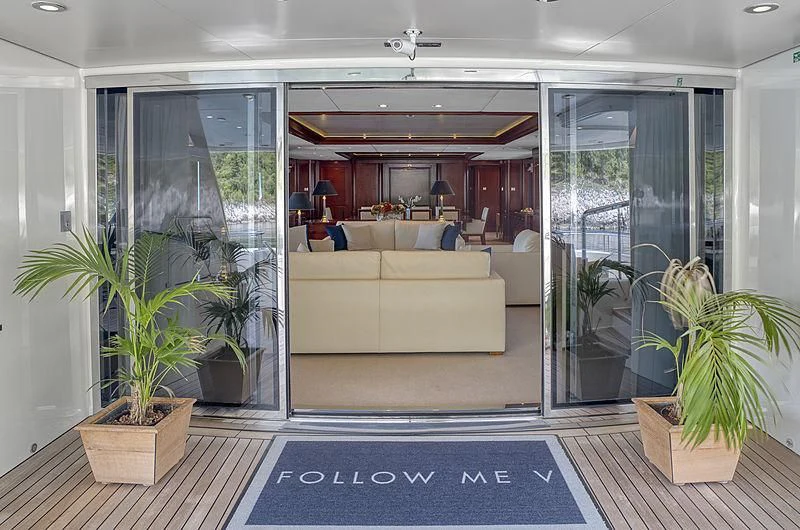 a living room with a glass door aboard TIREA Yacht for Sale