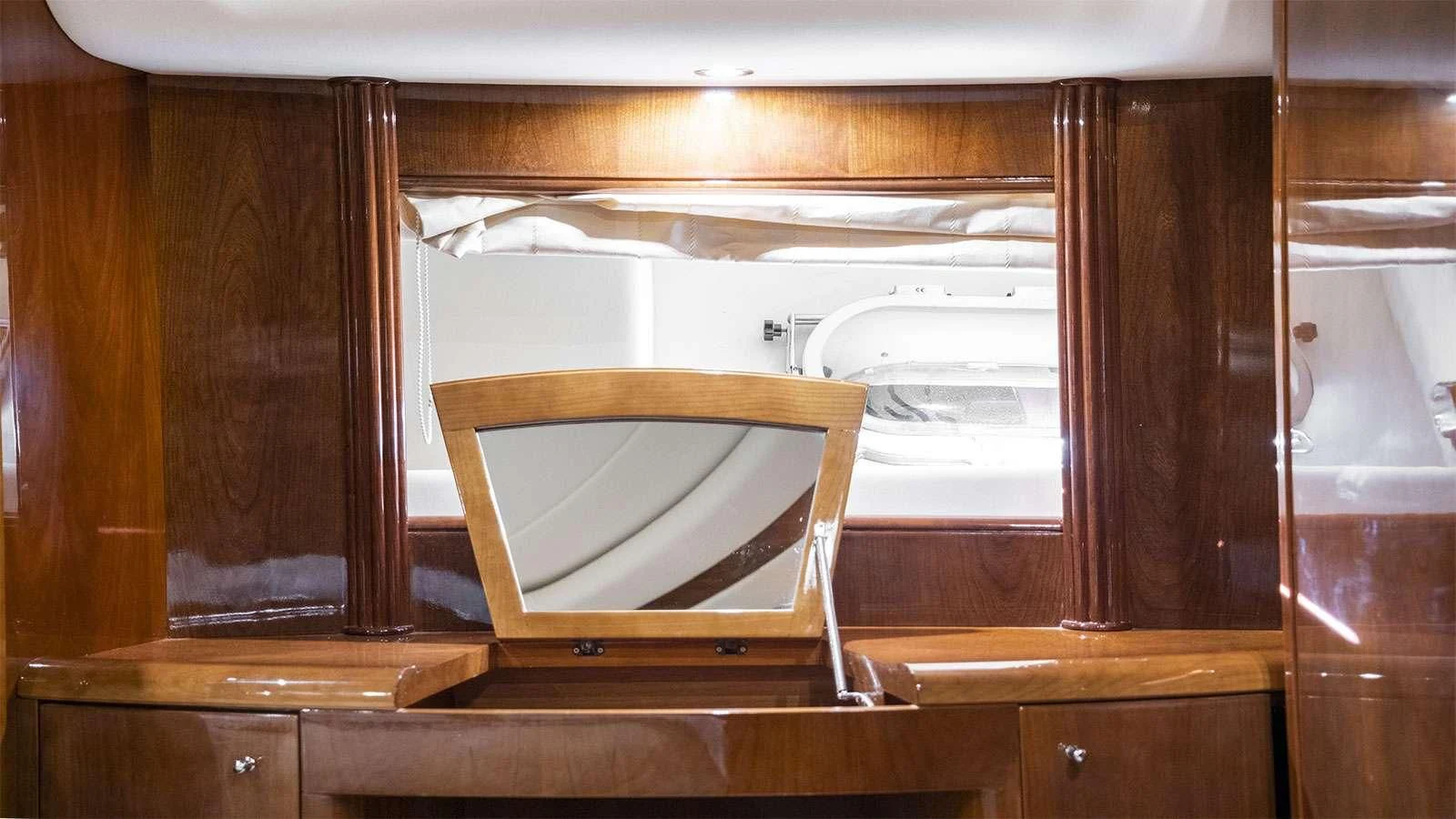 a wooden cabinet with a mirror aboard TITAN Yacht for Sale
