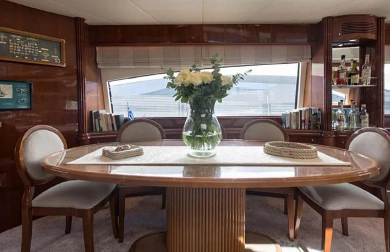 a vase of flowers on a table aboard TITAN Yacht for Sale