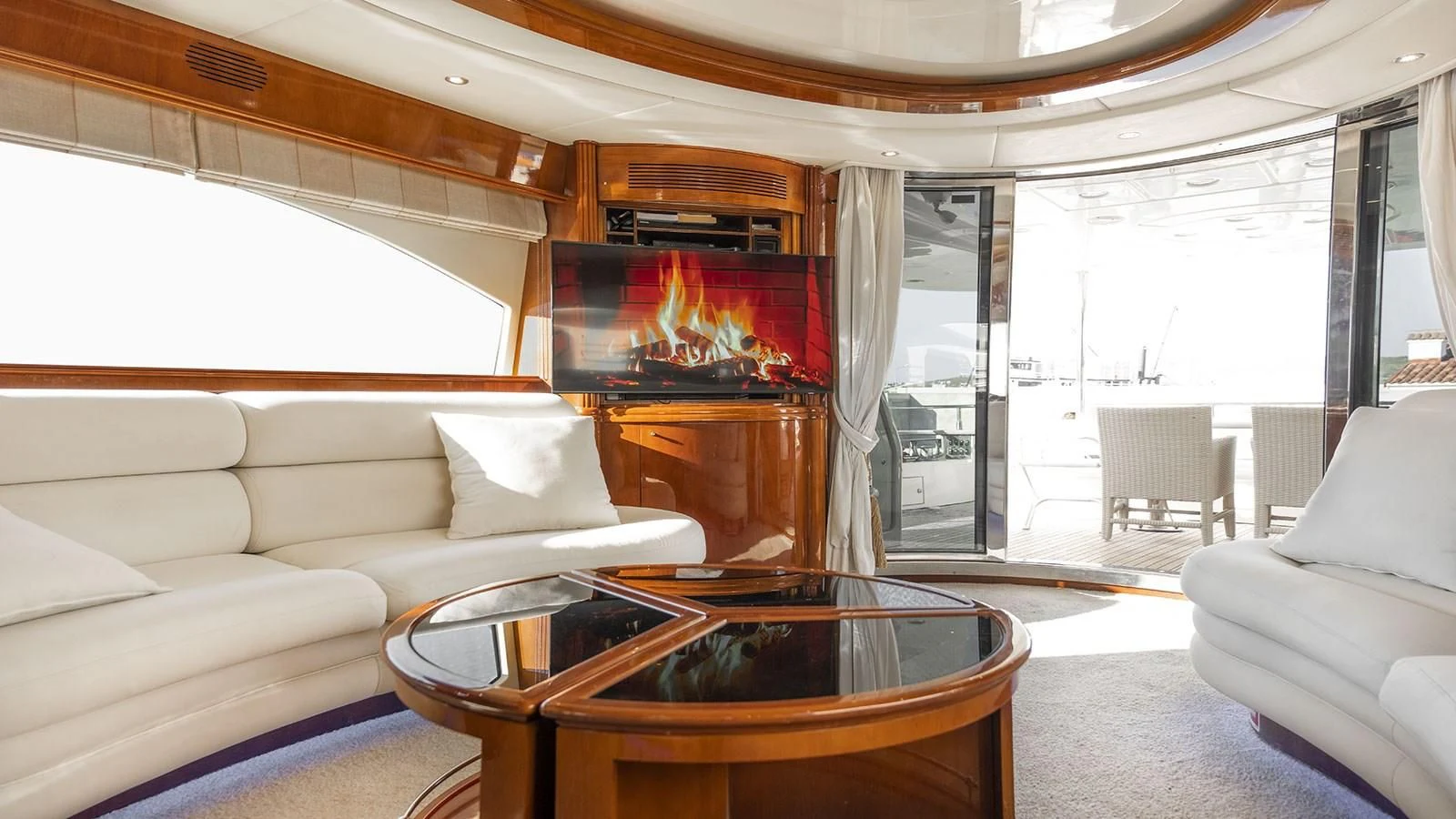a living room with a fireplace aboard TITAN Yacht for Sale