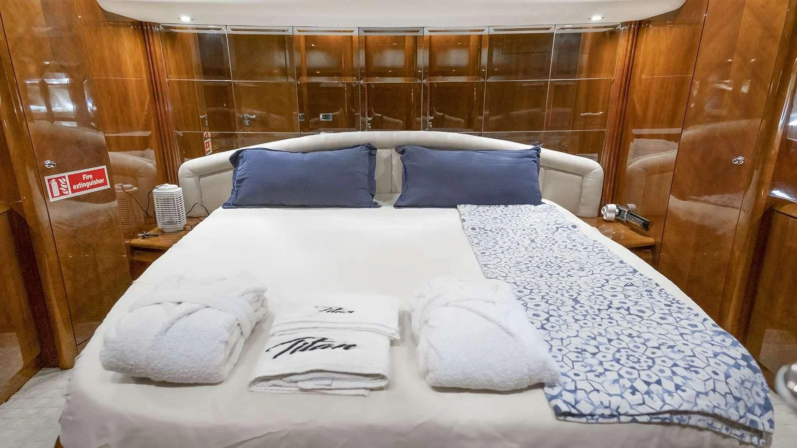 a bed with white sheets aboard TITAN Yacht for Sale