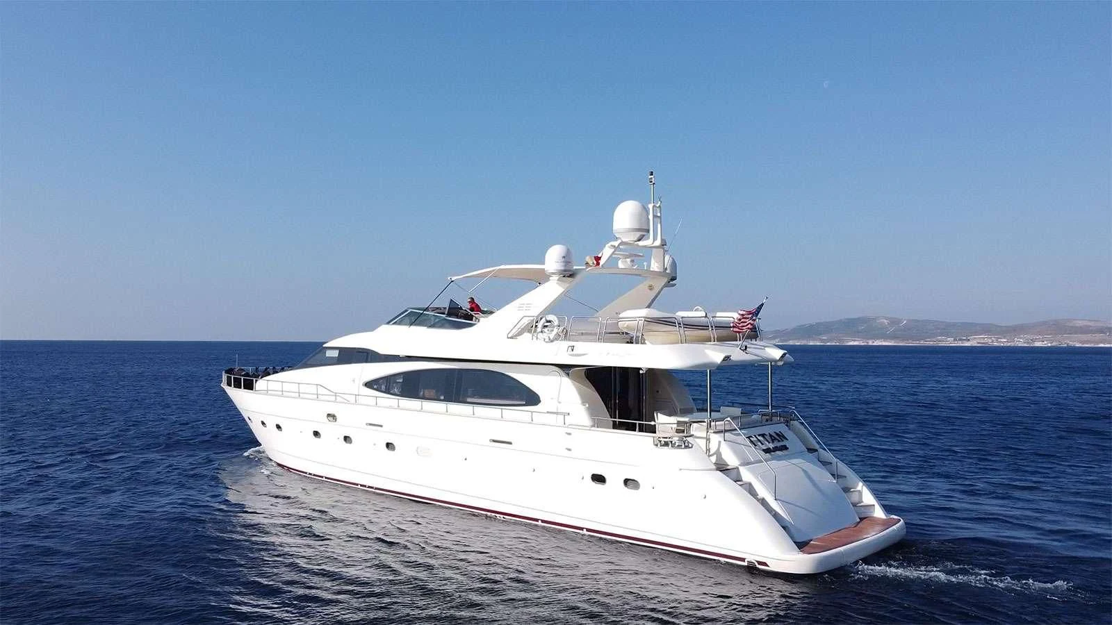 a white yacht on the water aboard TITAN Yacht for Sale