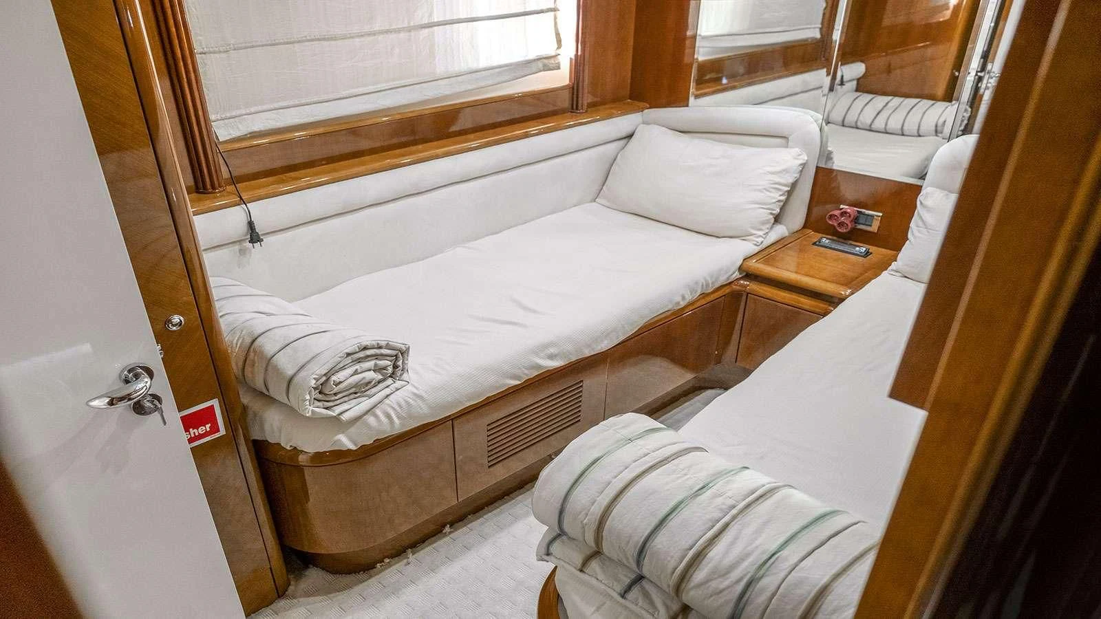 a room with two beds aboard TITAN Yacht for Sale