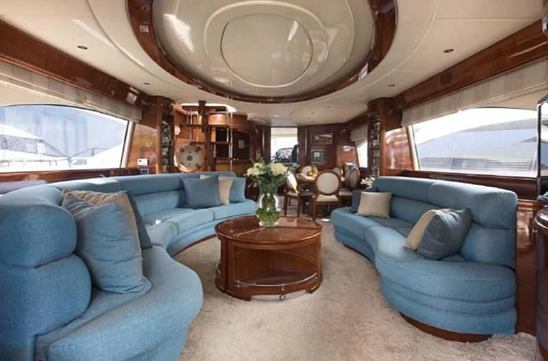 a living room with a large window aboard TITAN Yacht for Sale