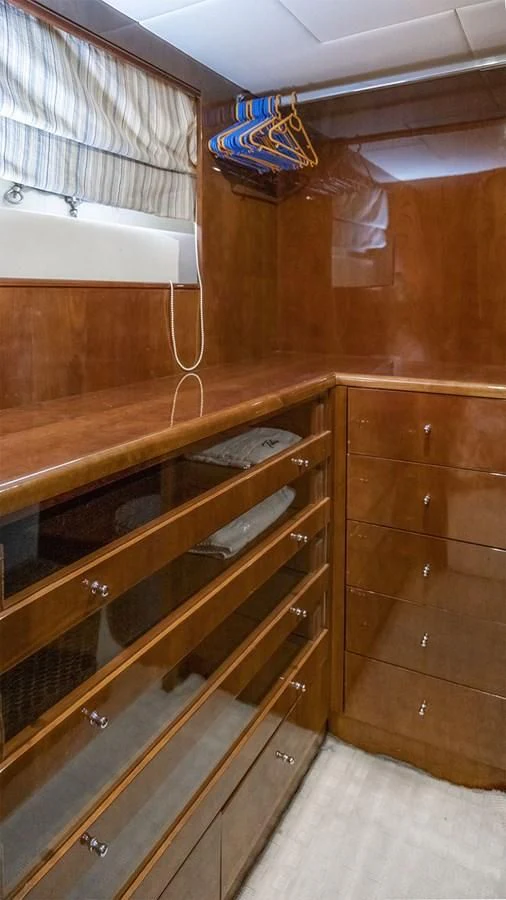 a wooden dresser with a towel from it aboard TITAN Yacht for Sale