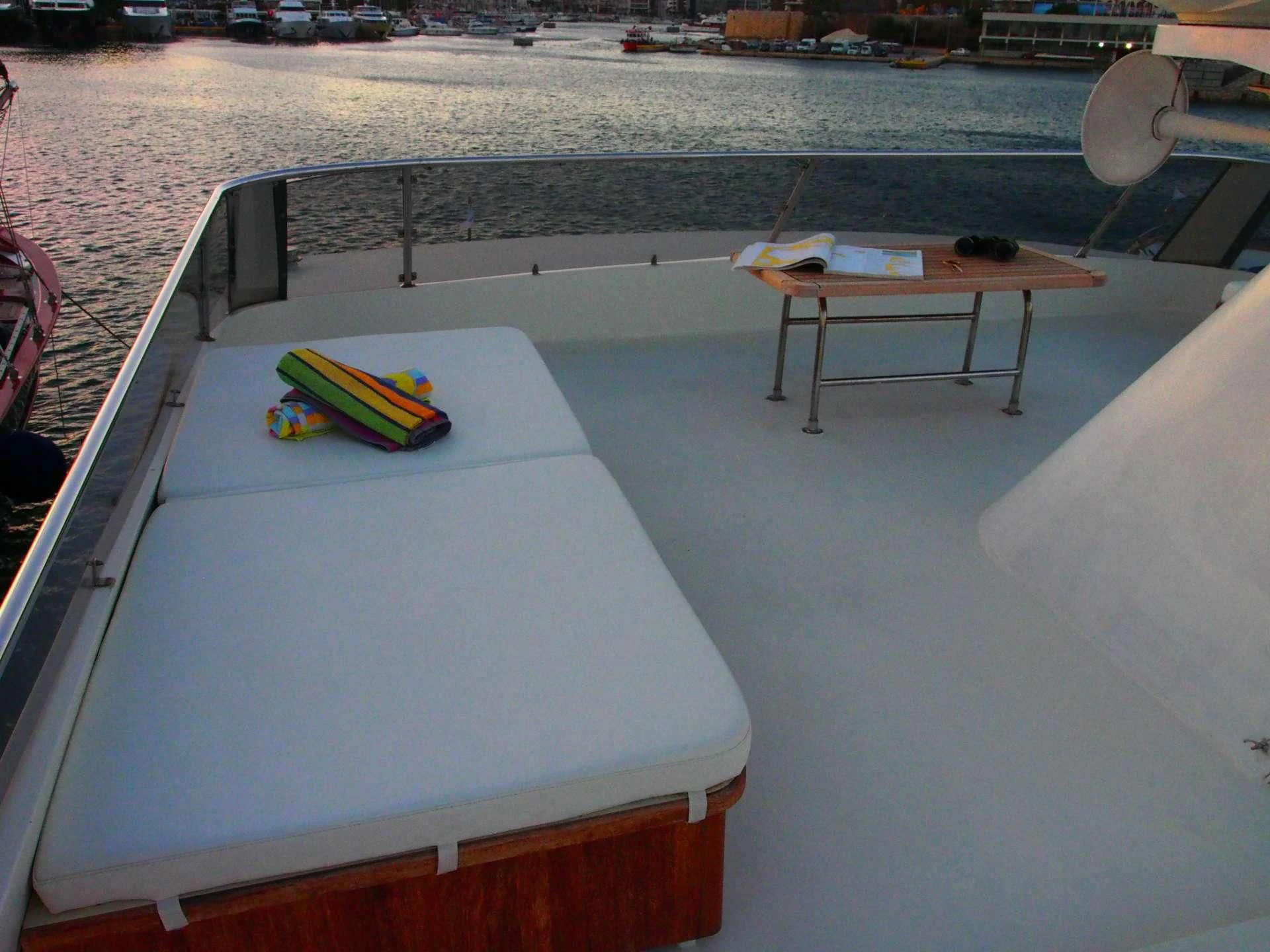 a table and a chair on a balcony aboard K Yacht for Sale