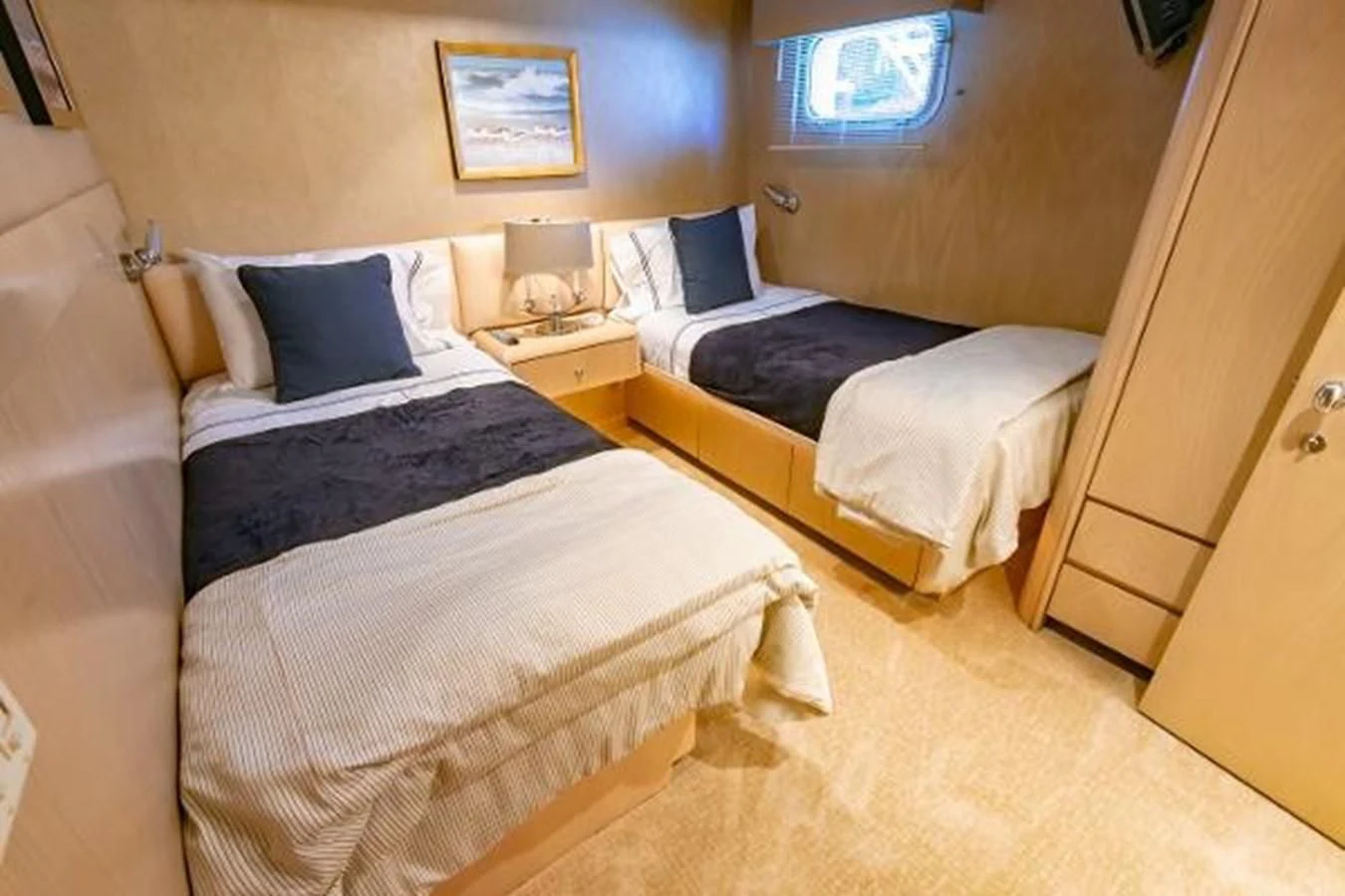 a room with beds and a window aboard K Yacht for Sale