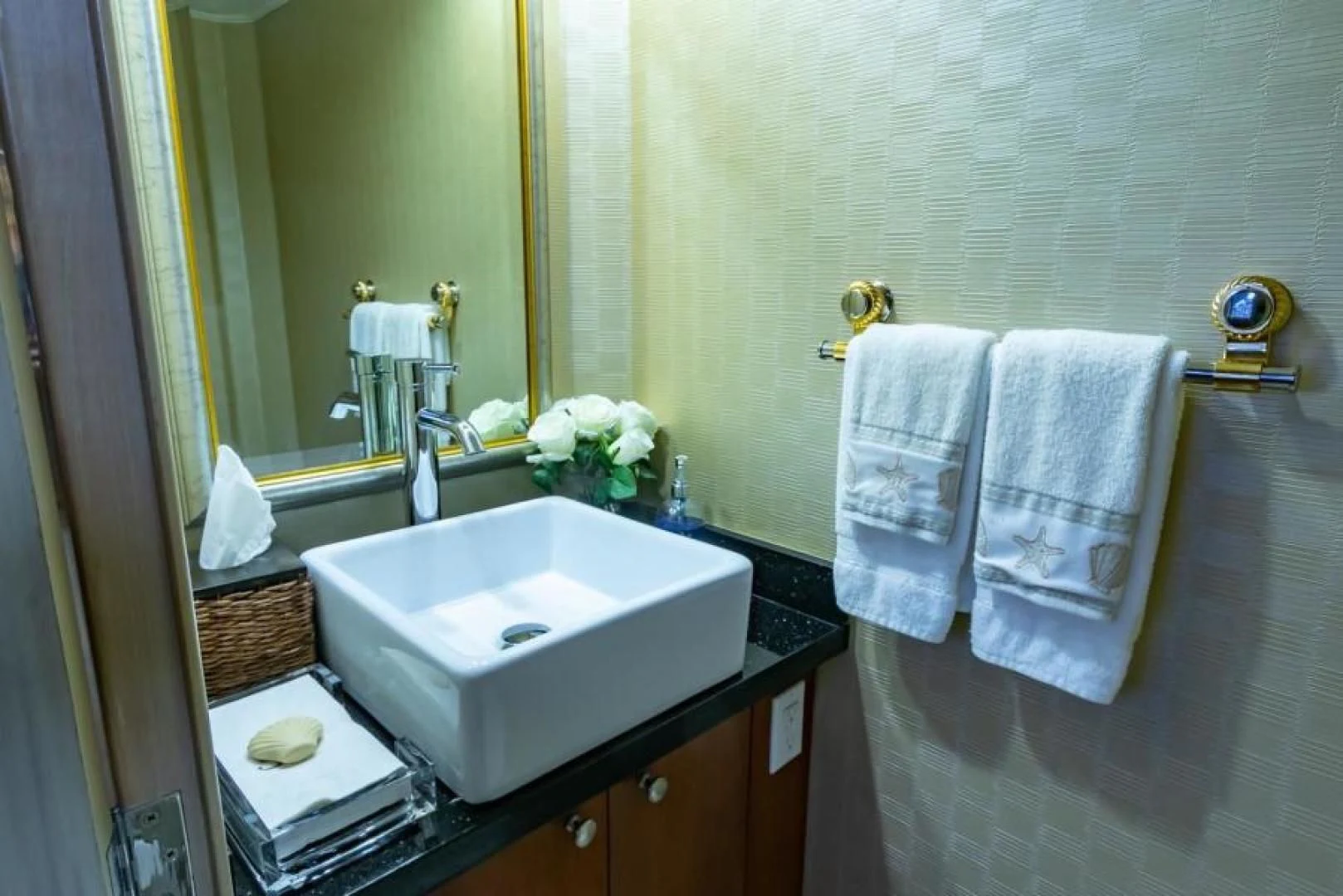 a bathroom with a sink and towels aboard K Yacht for Sale