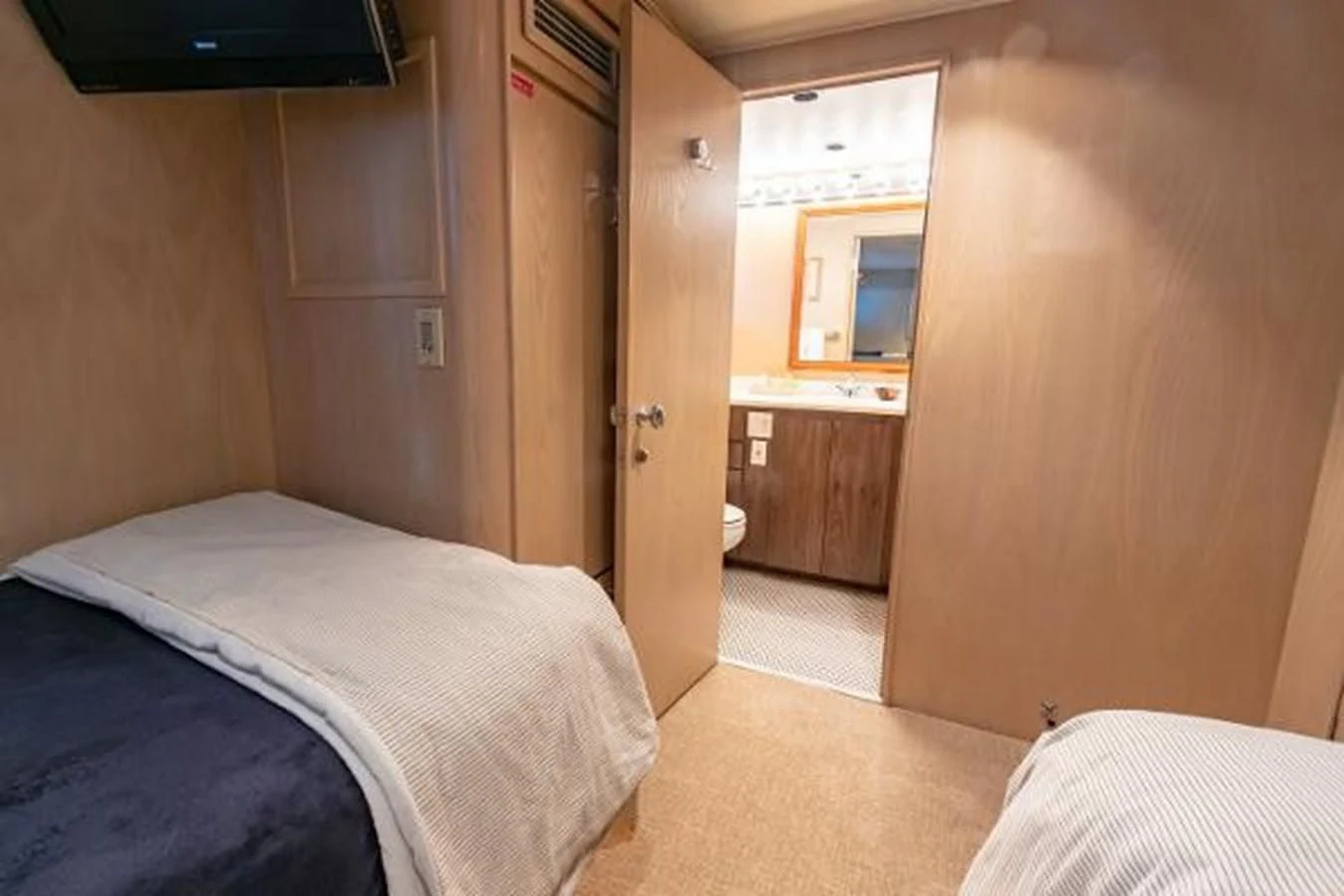 a room with a bed and a television aboard K Yacht for Sale
