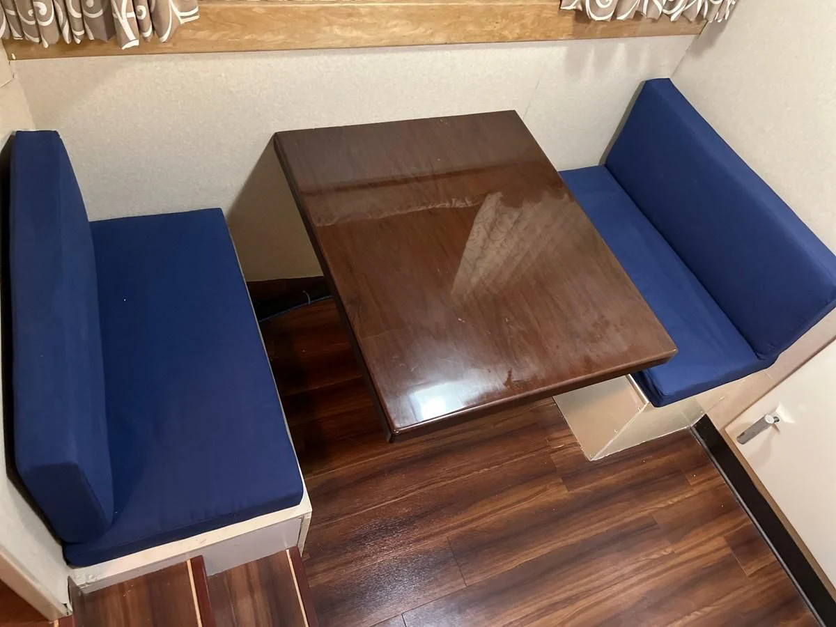 a chair and a table aboard K Yacht for Sale