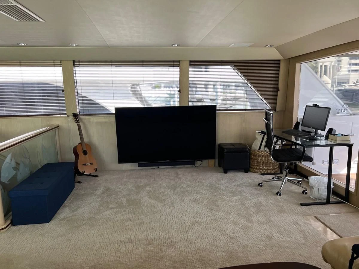 a room with a black screen and a guitar in it aboard K Yacht for Sale